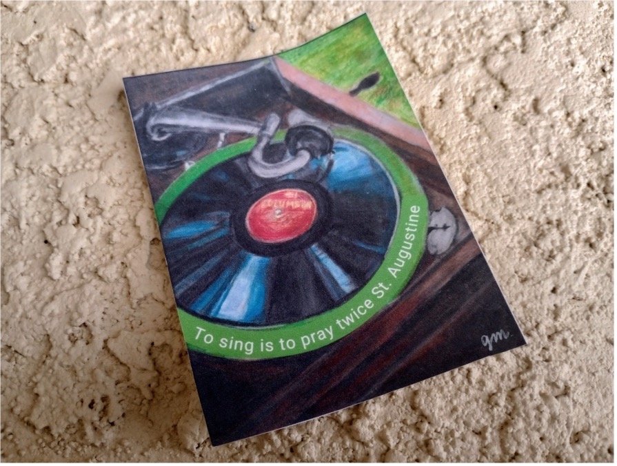 Painting of a vinyl record player with a quote: 'To sing is to pray twice' by St. Augustine, on a beige carpet.