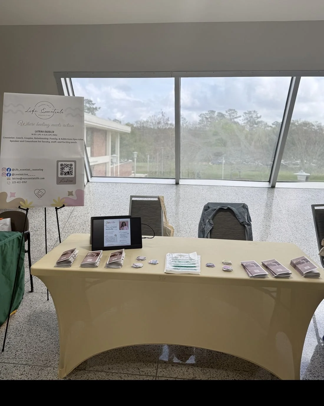 The Life Essentials outreach table with flyers and a banner