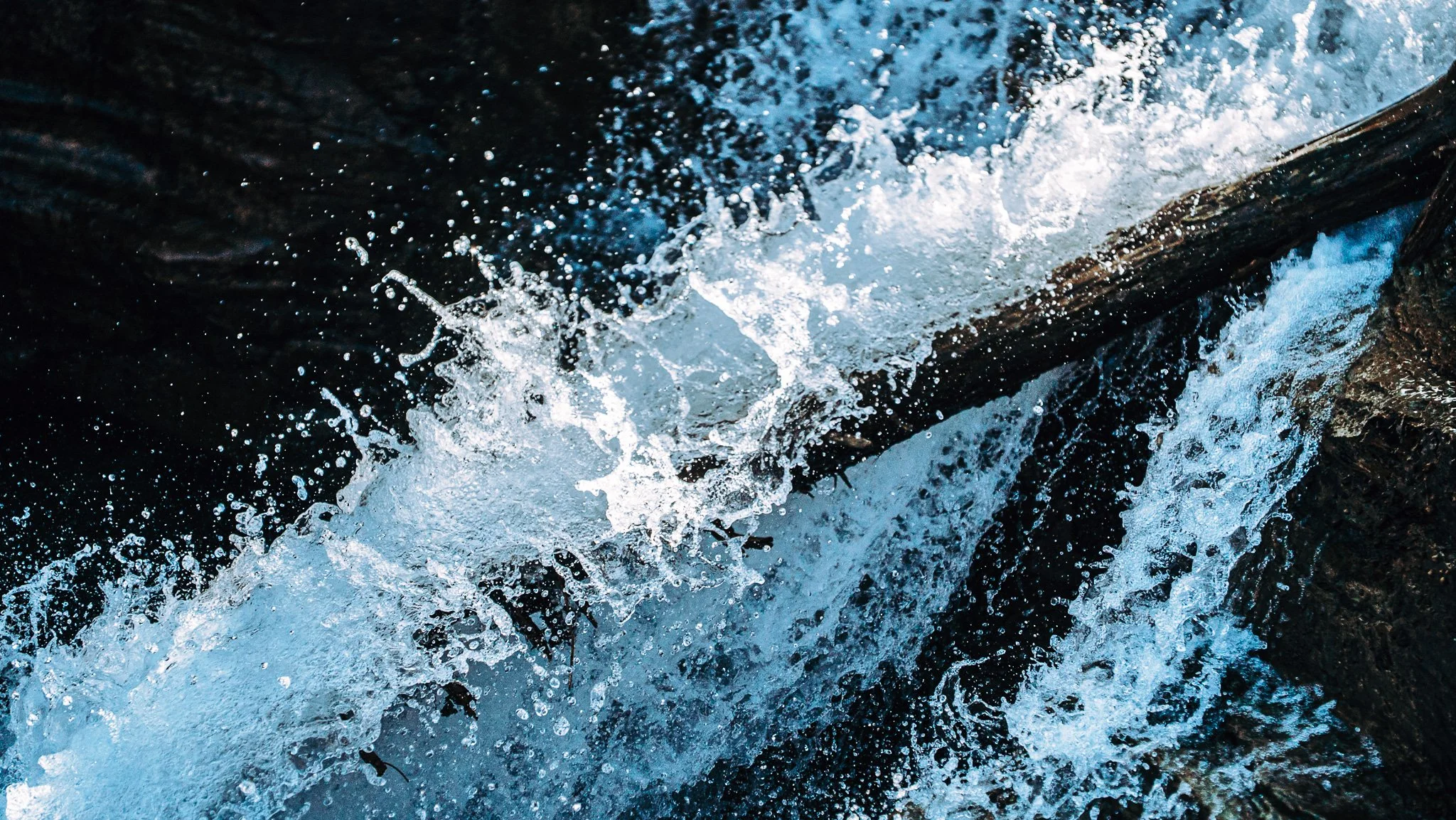 Close-up of water splashing over rocks in a river or creek.