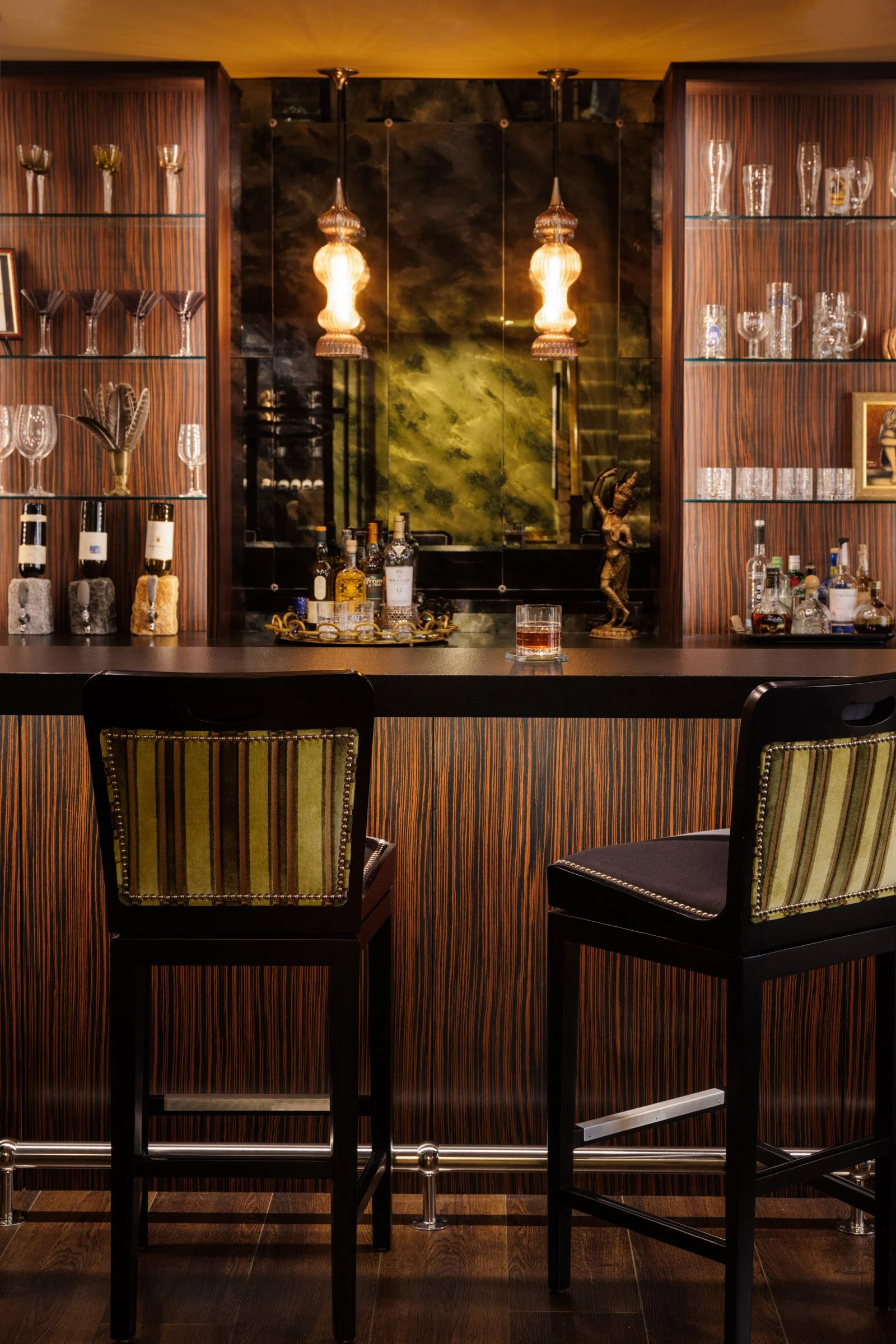 Custom home bar cabinetry displaying glassware