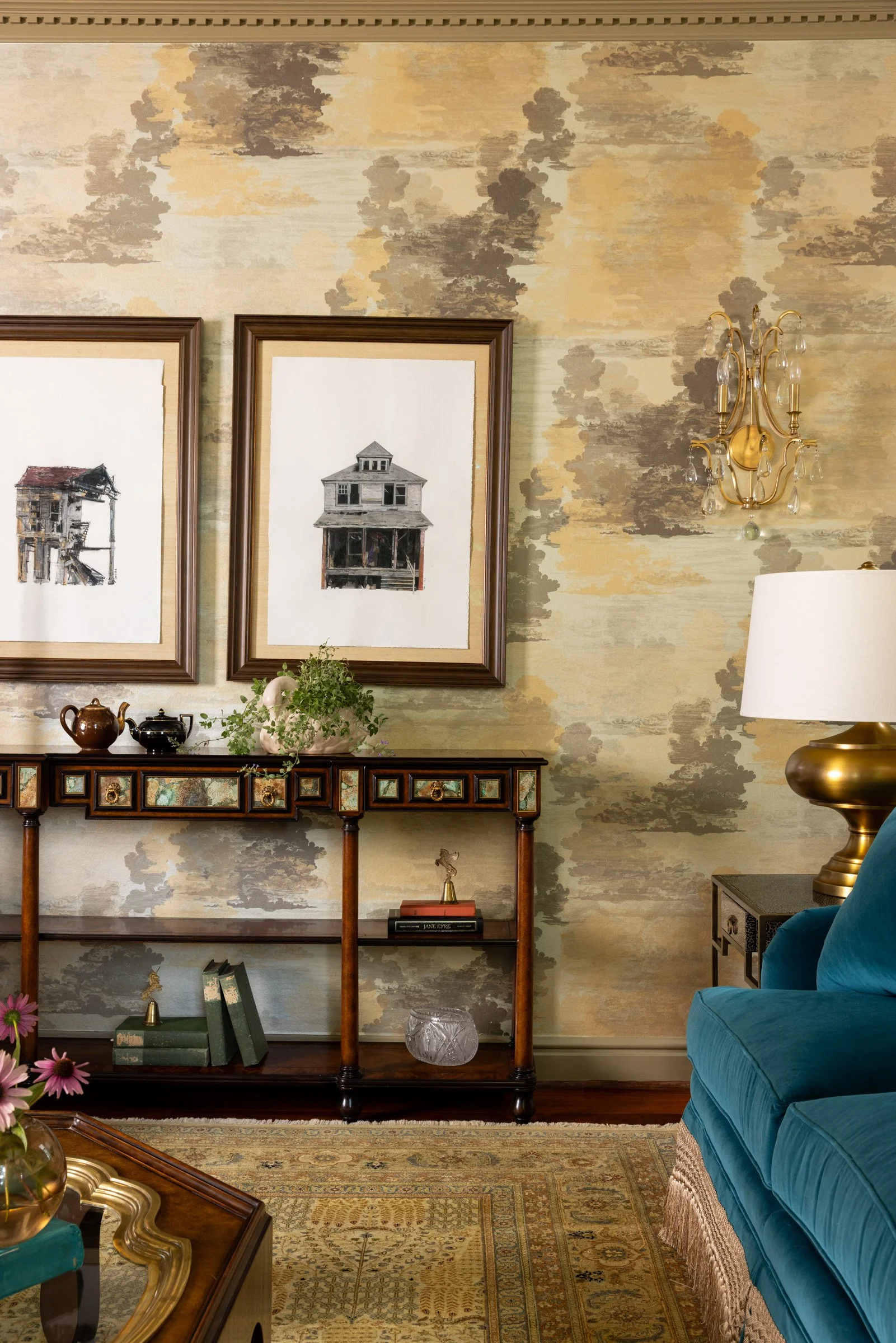 Antique-style console, framed artwork, and patterned wallcovering
