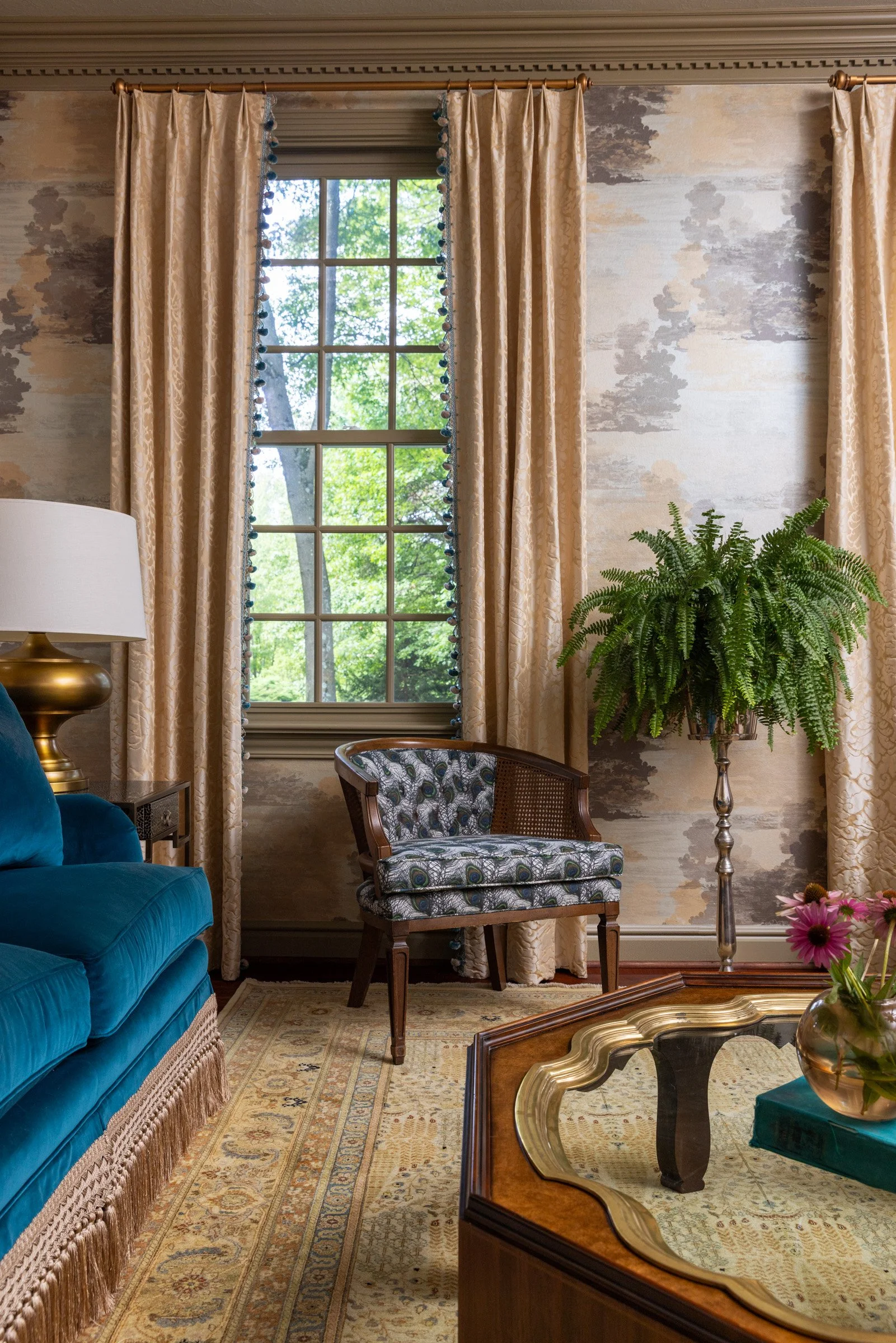 Patterned accent chair beside custom drapery in the living room