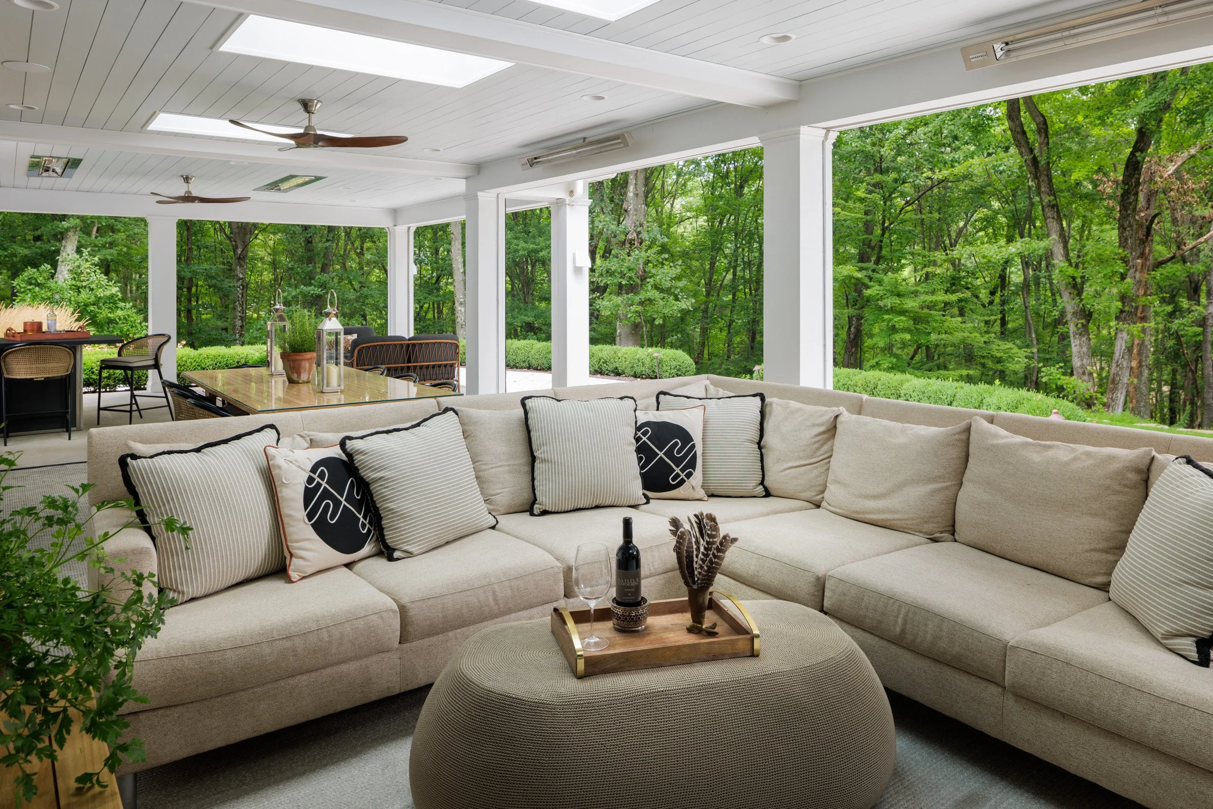 Outdoor sectional seating with patterned cushions and wooded views