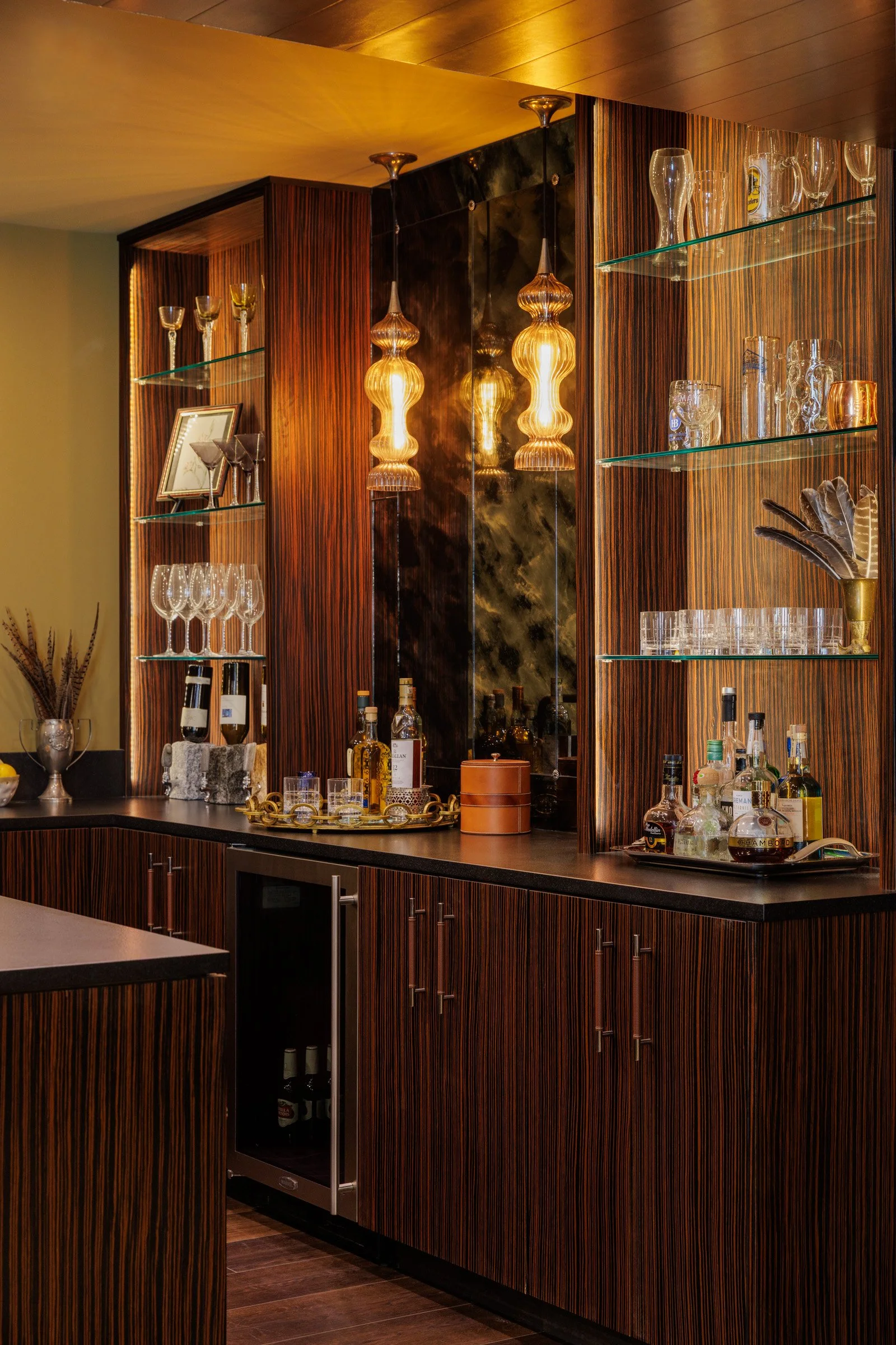Glass-front bar cabinets and warm wood finishes