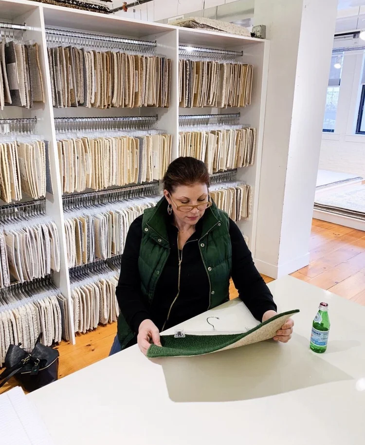 Marjorie reviewing textile samples for an interior design project