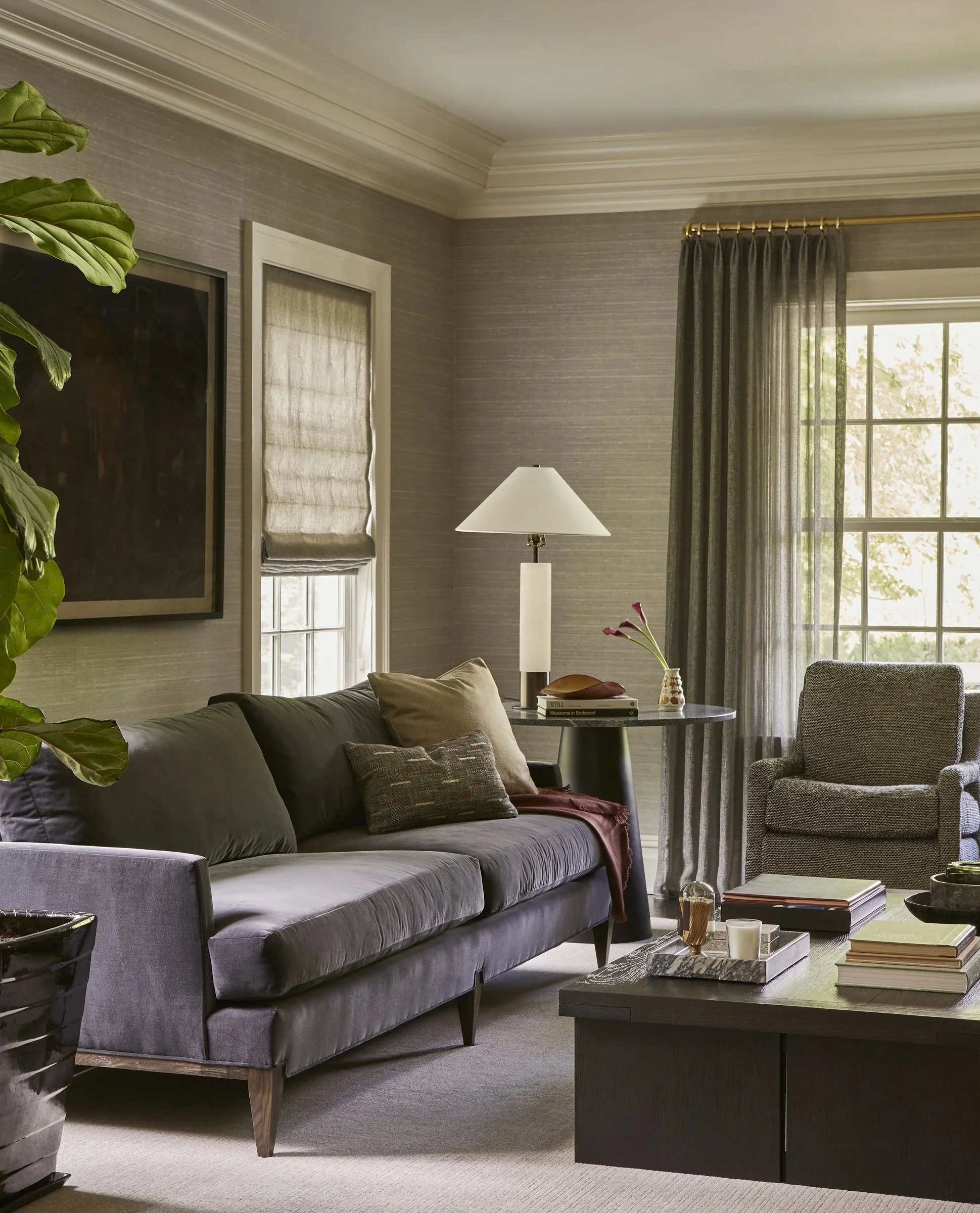 Living room with a gray sofa, armchair and tall windows