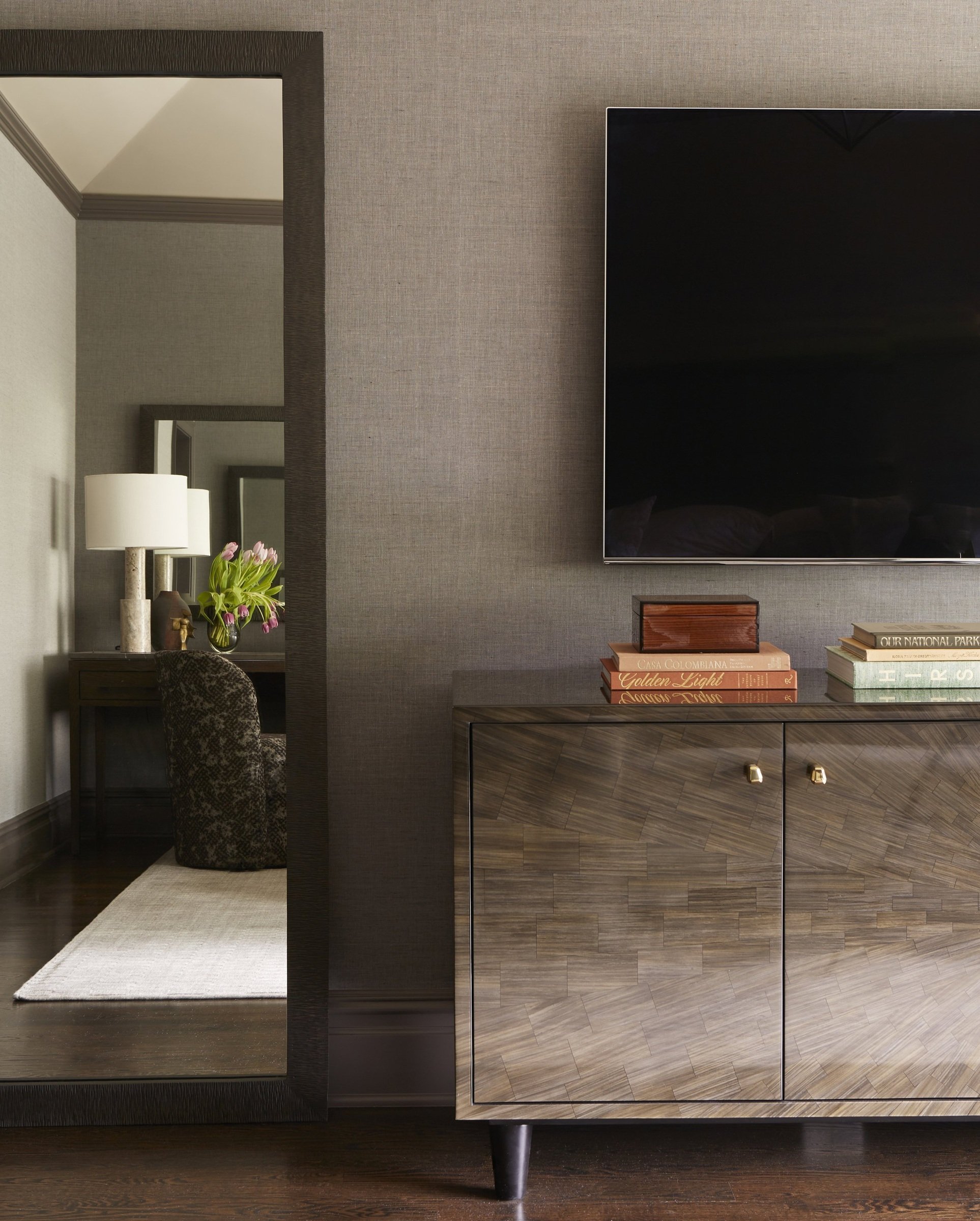 Living room wall with a television above a low wood cabinet