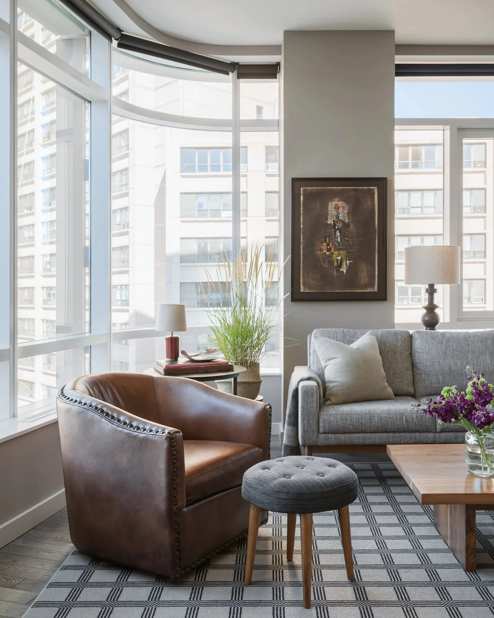 Living room with a brown armchair beside tall windows