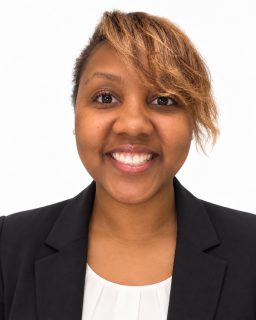 Smiling woman in a black blazer against a clean white background.
