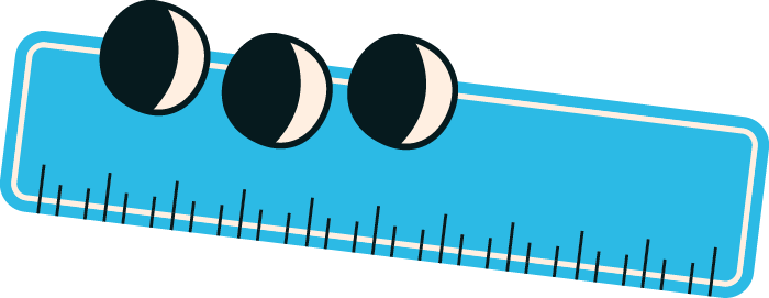 Close-up of a blue ruler with three black and white circular objects on top.