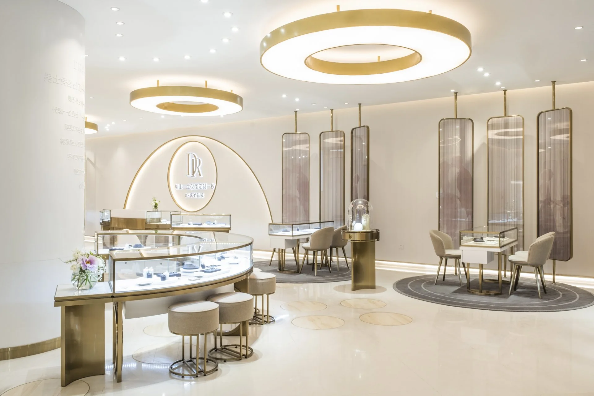 Elegant jewelry store interior with display cases, plush seating, and modern lighting fixtures.