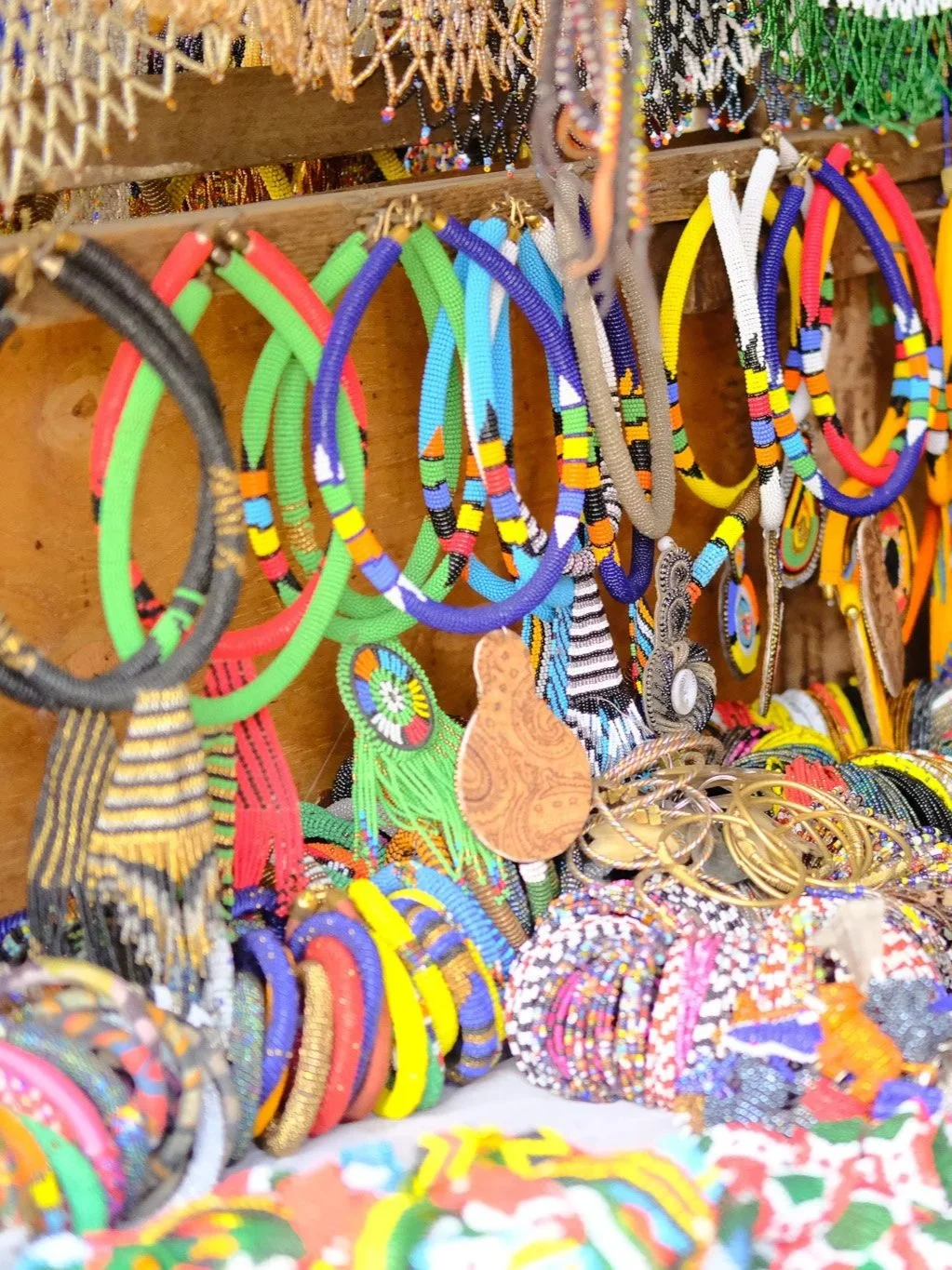 Colorful beaded jewelry, including necklaces, bracelets, and earrings are on offer at Rwanda Trek in Musanze.