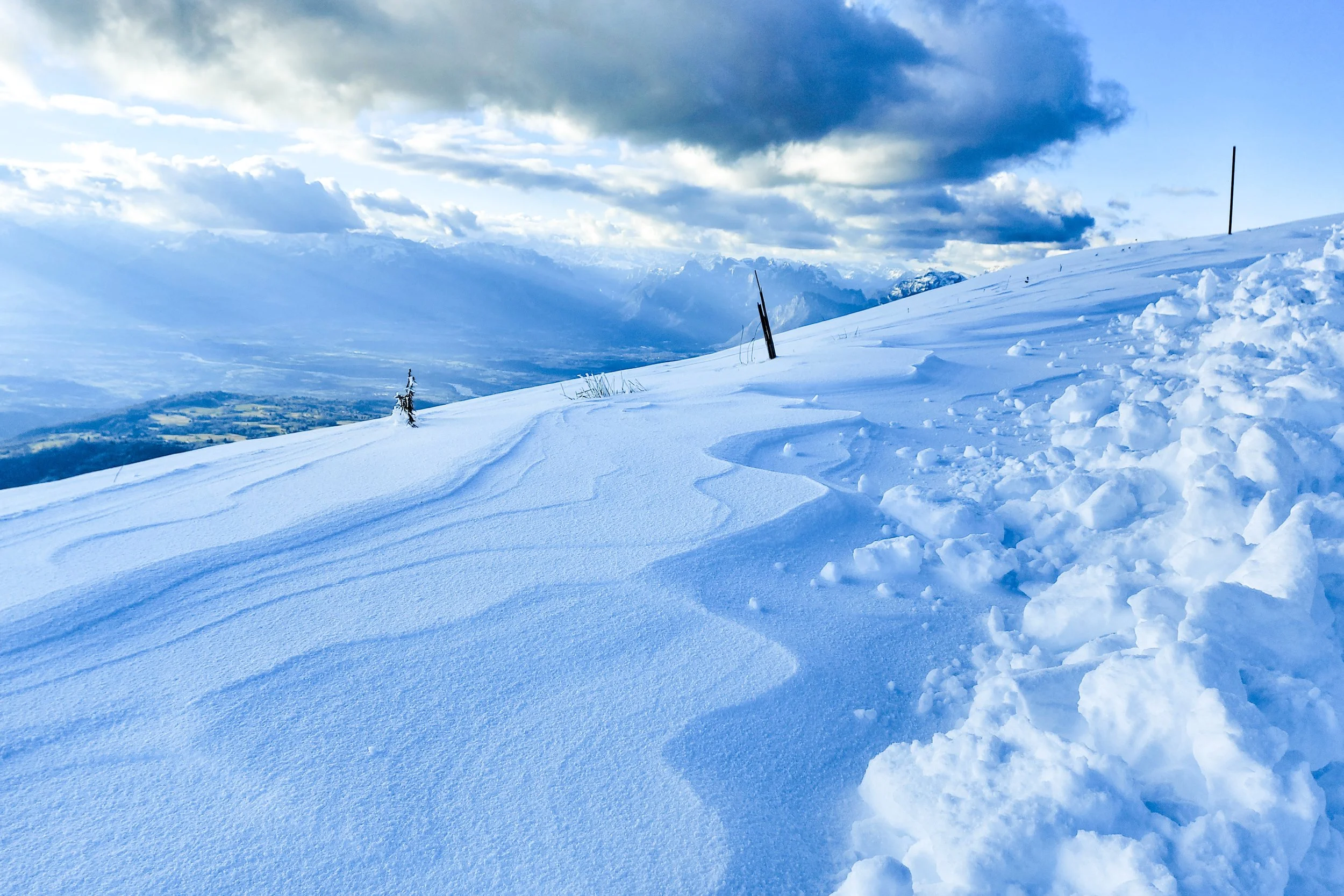 Landscape photo of snow patterns created by wind on Col Visentin in Italy.