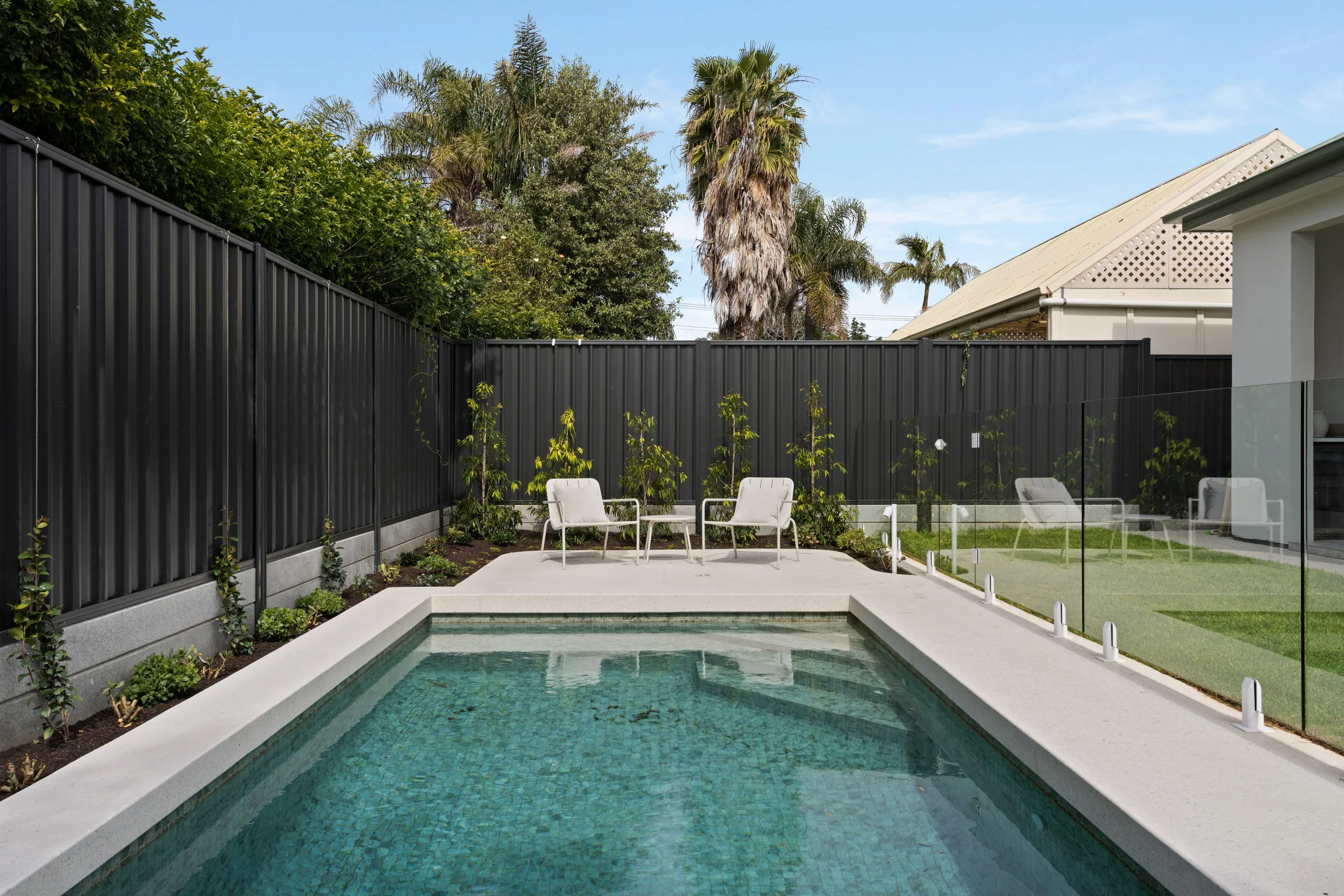 Swimming pool and landscaped garden behind the Glenelg North home