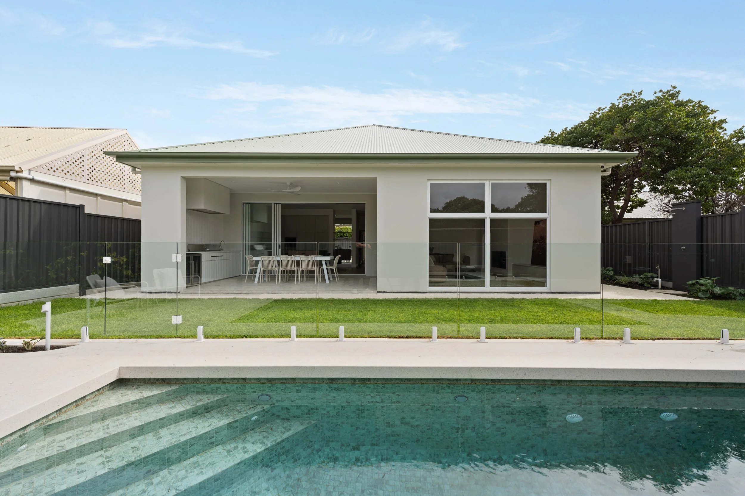 Rear façade and covered entertaining area overlooking the Glenelg North pool