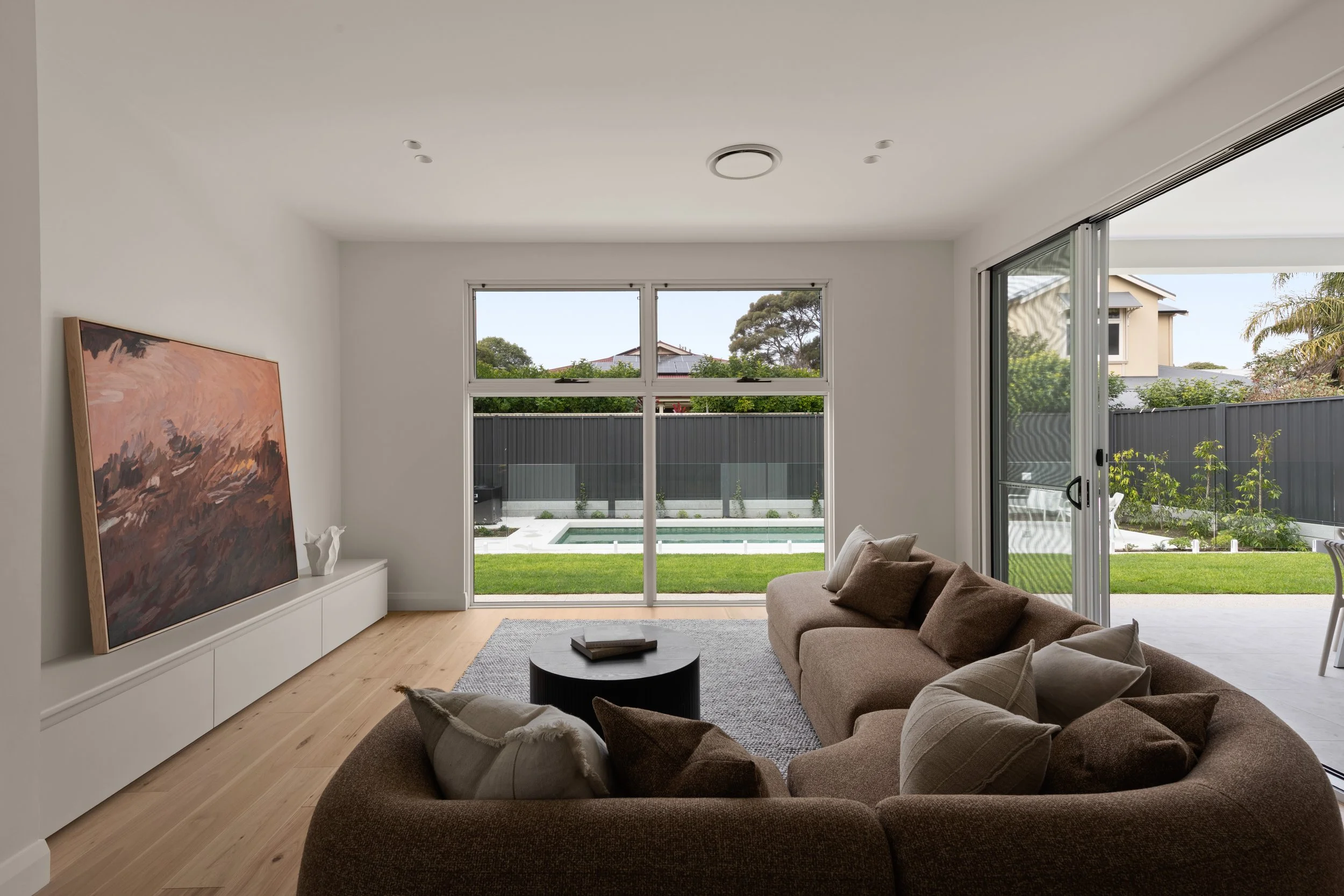 Curved sofa and garden views in the Glenelg North living room