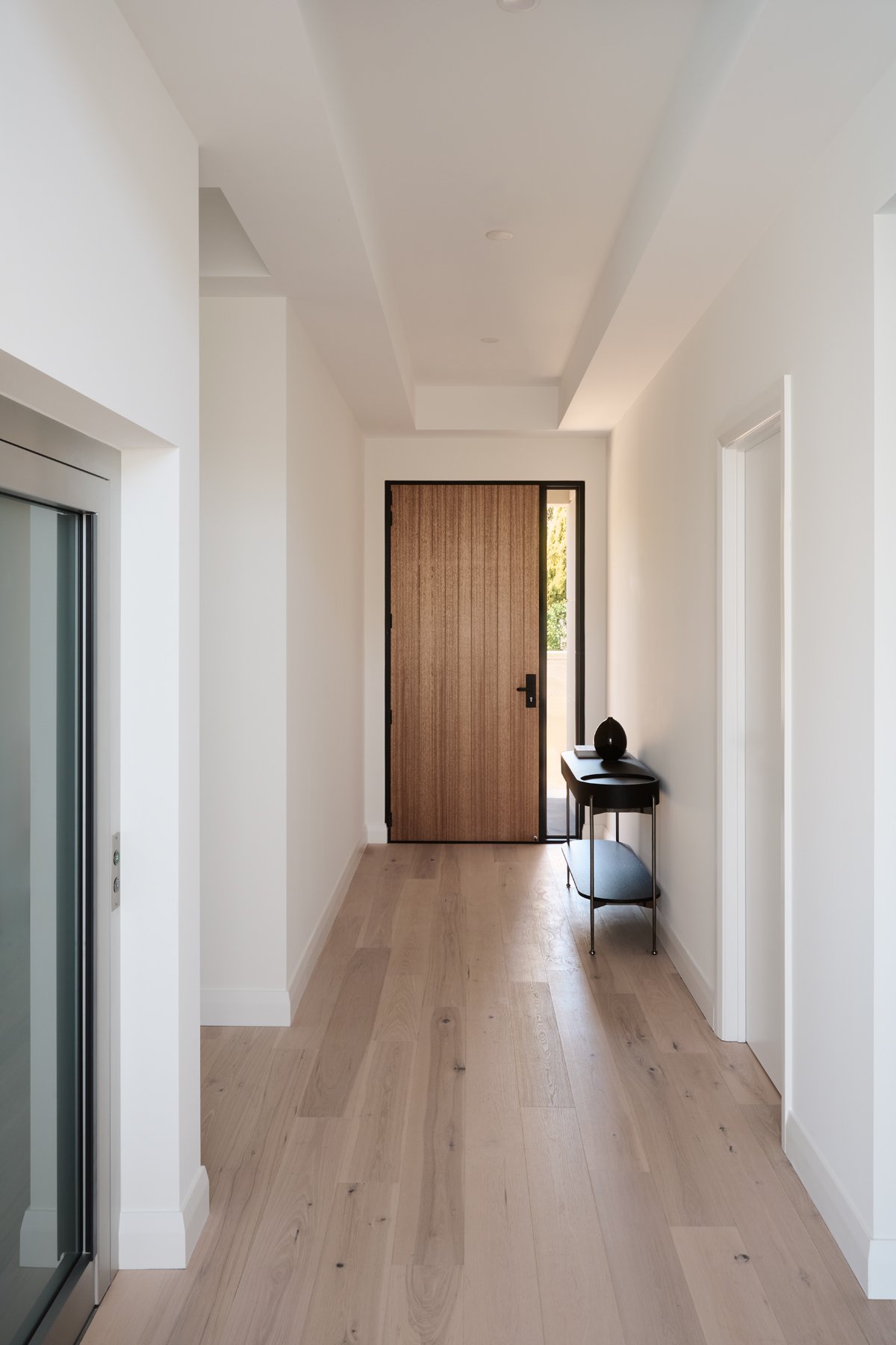 Timber-floored hallway leading to a tall timber door in Hazelwood Park
