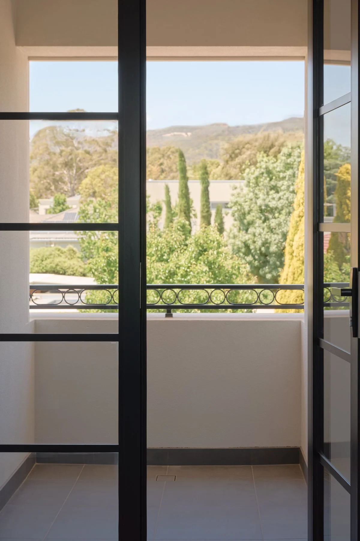 Dark-framed doors opening to a balcony at the Hazelwood Park home