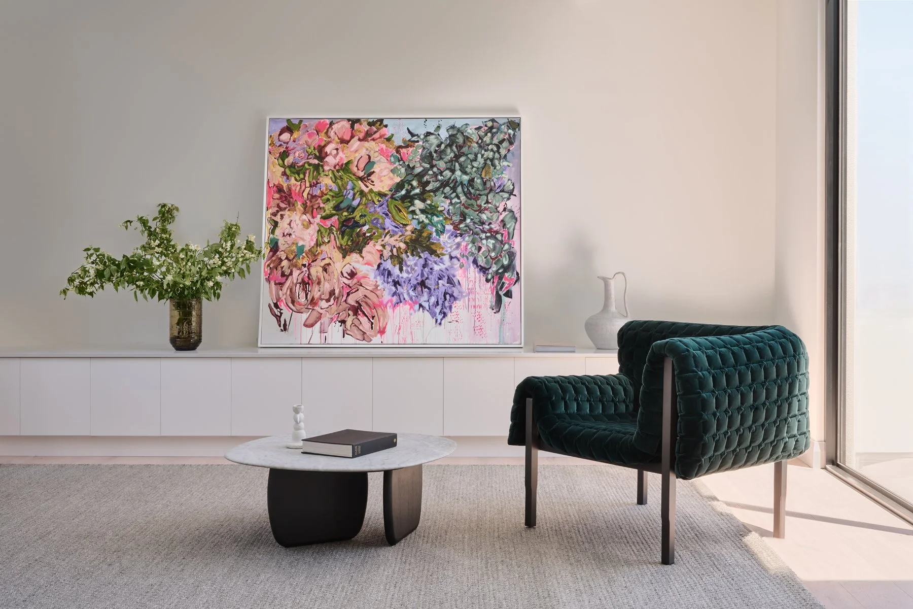 Green armchair, floral artwork and low table in the Hazelwood Park living room