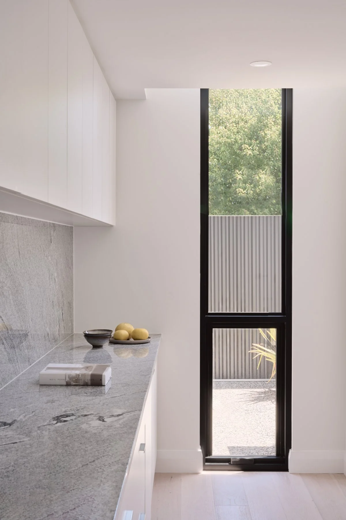 Natural stone kitchen splashback beside a tall window in Hazelwood Park
