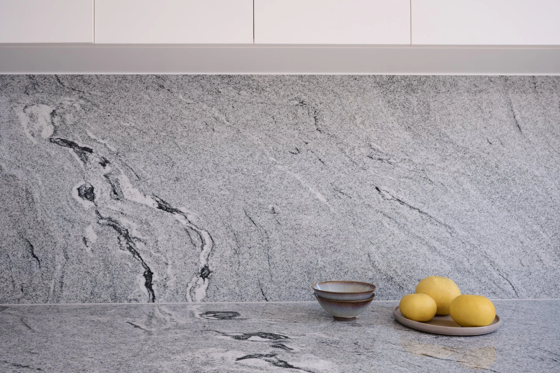 Detail of the veined natural stone splashback in the Hazelwood Park kitchen