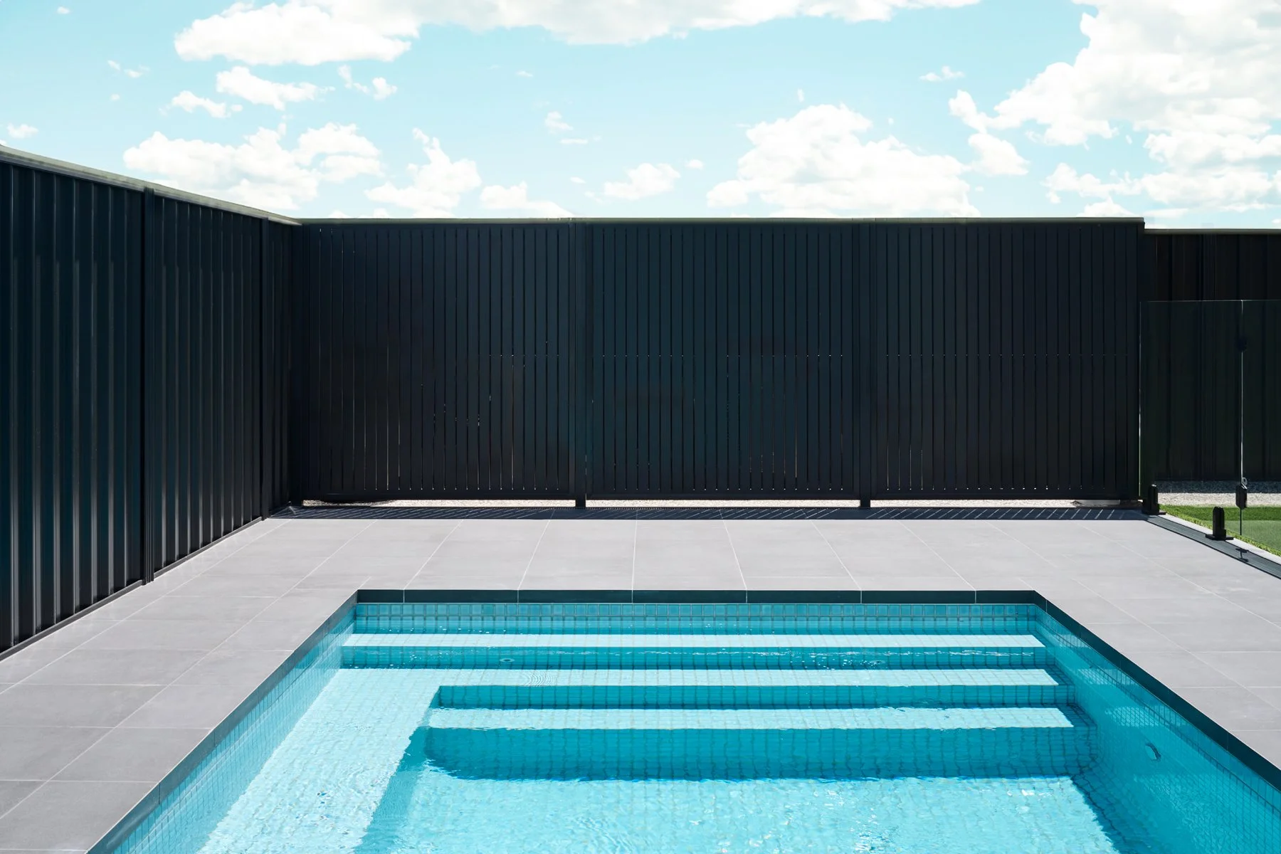 Swimming pool steps and dark boundary fence in Hazelwood Park
