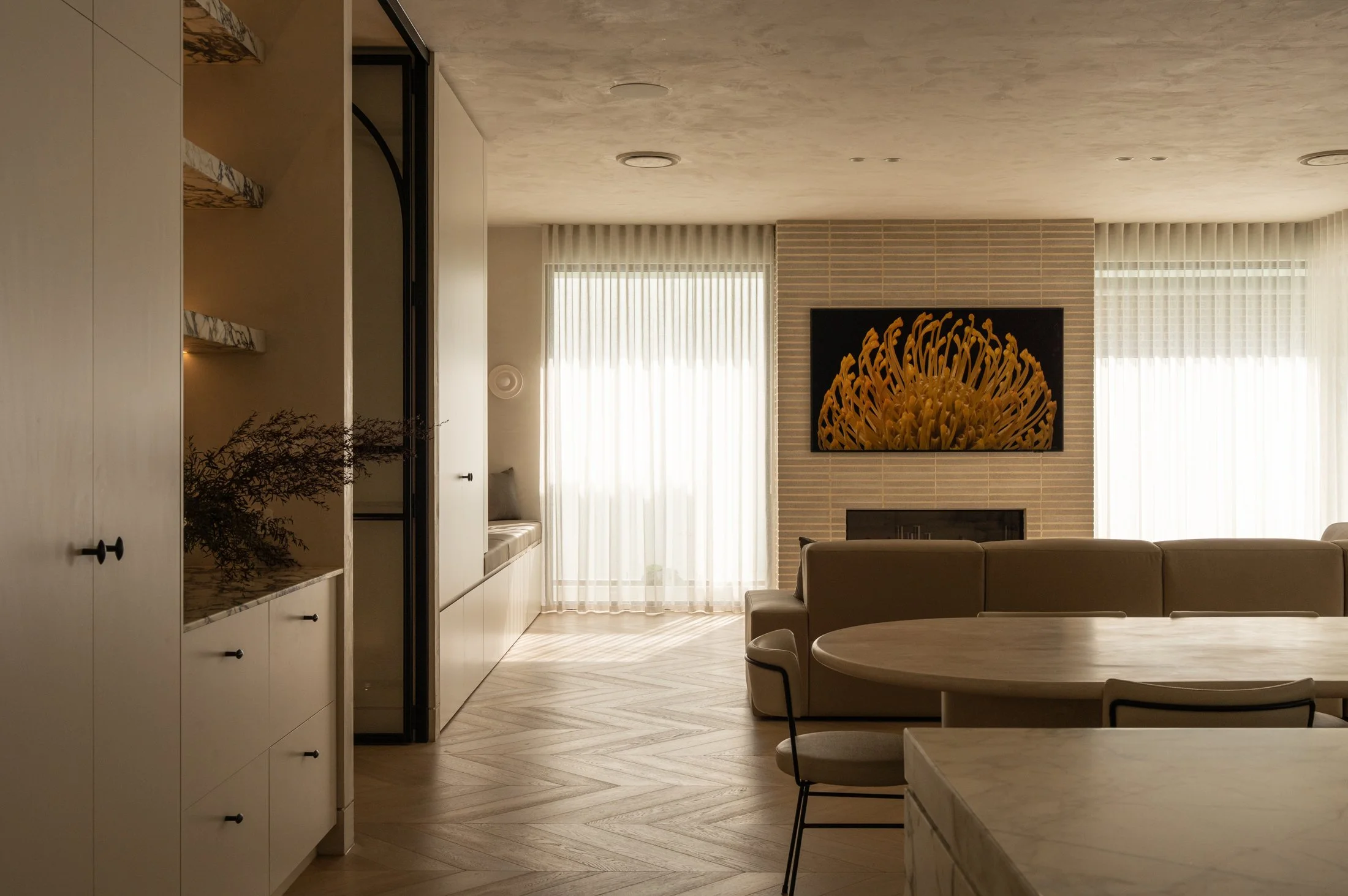 St Morris living room with textured plaster ceiling, fireplace and artwork