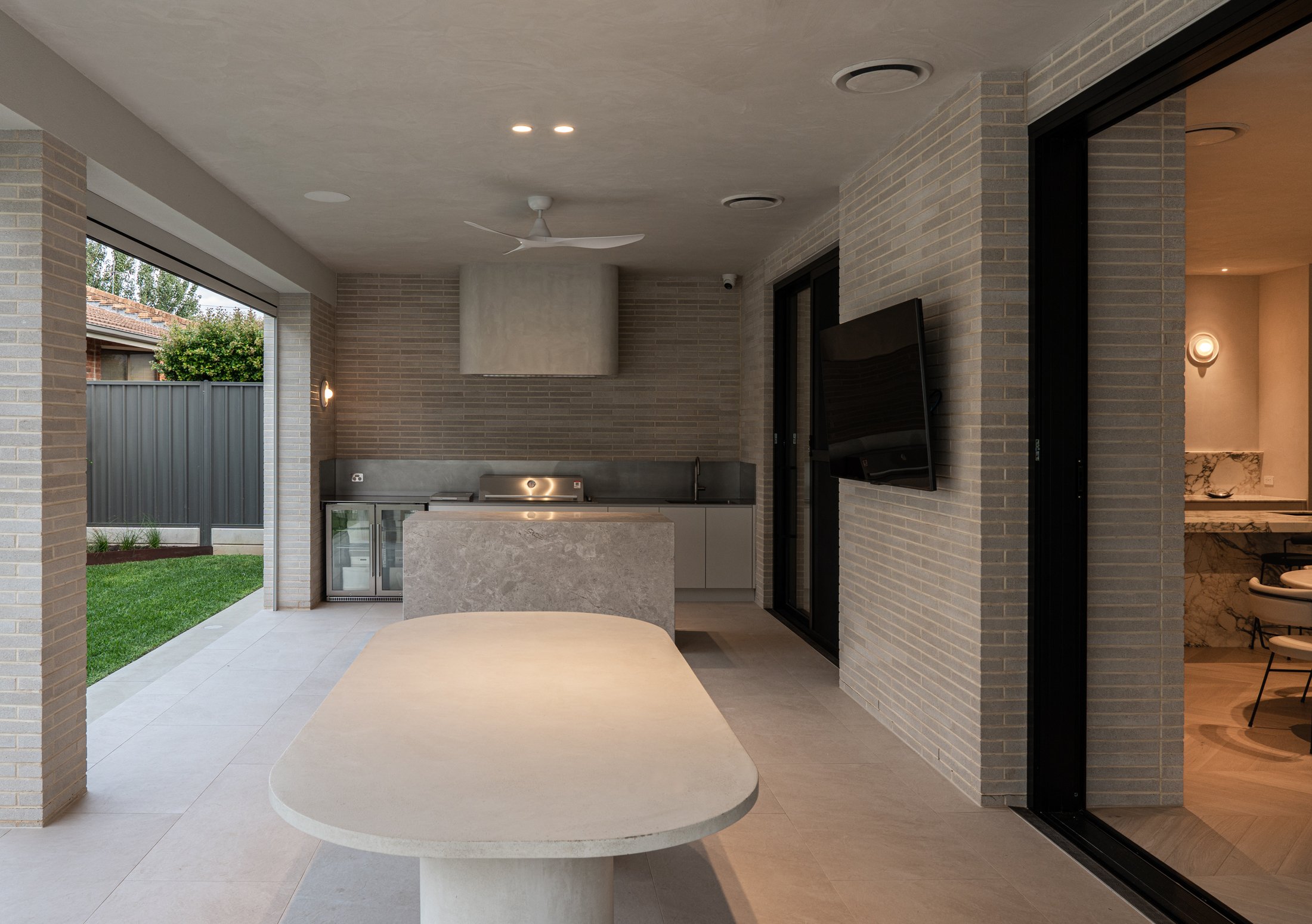Open-plan St Morris kitchen with a stone island and dark cabinetry