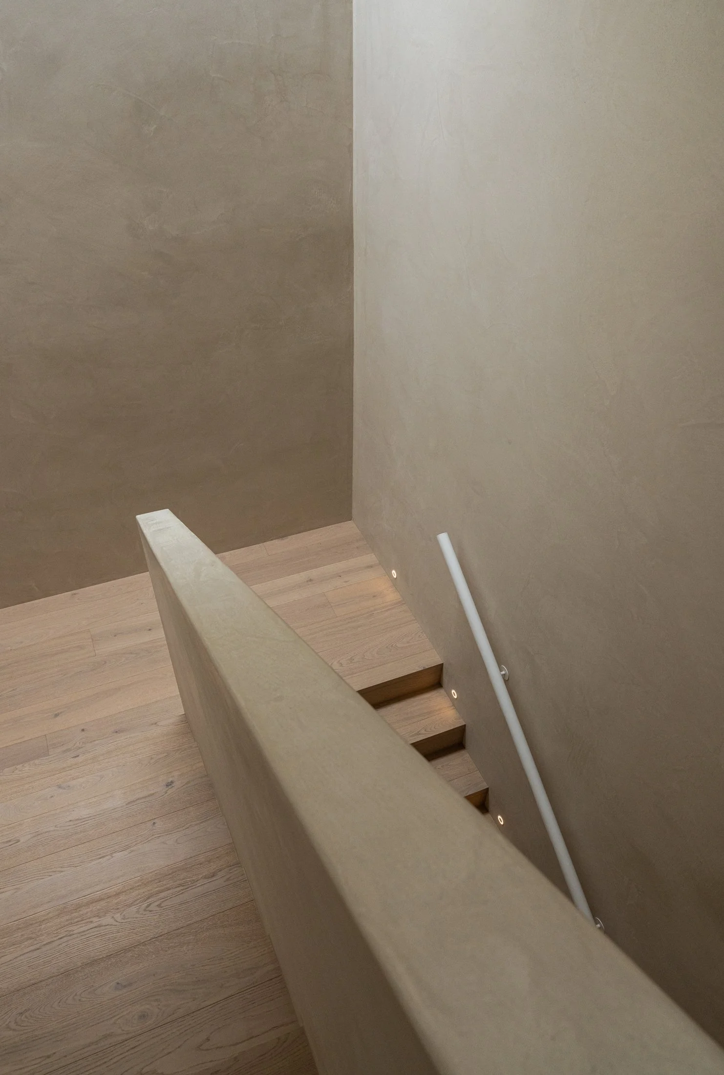 Pale stairwell and timber stair treads in the St Morris interior