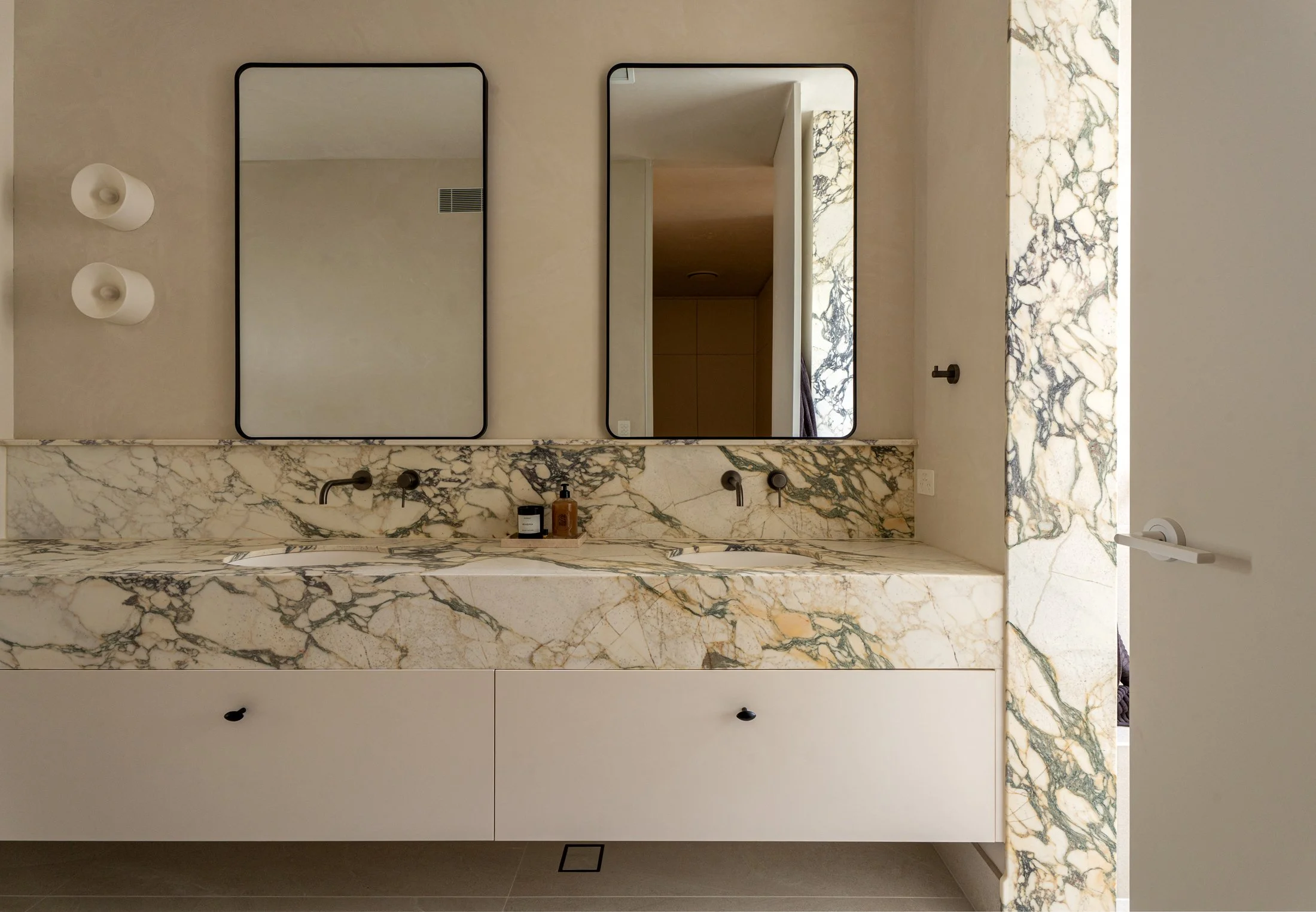 Twin-basin stone vanity and mirrors in the St Morris bathroom