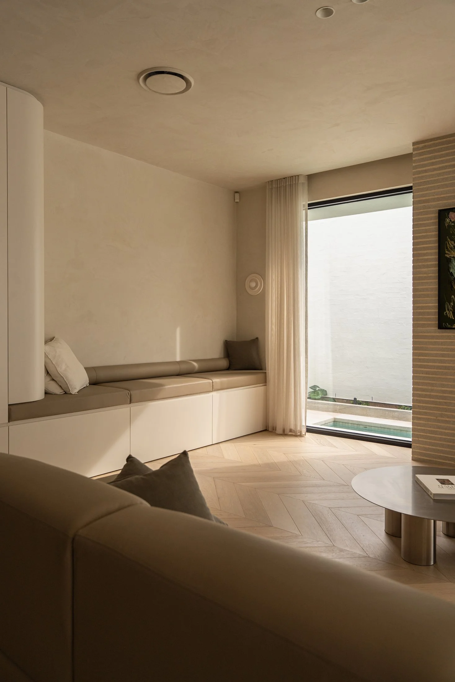 St Morris living room with fitted cabinetry and full-height glazing