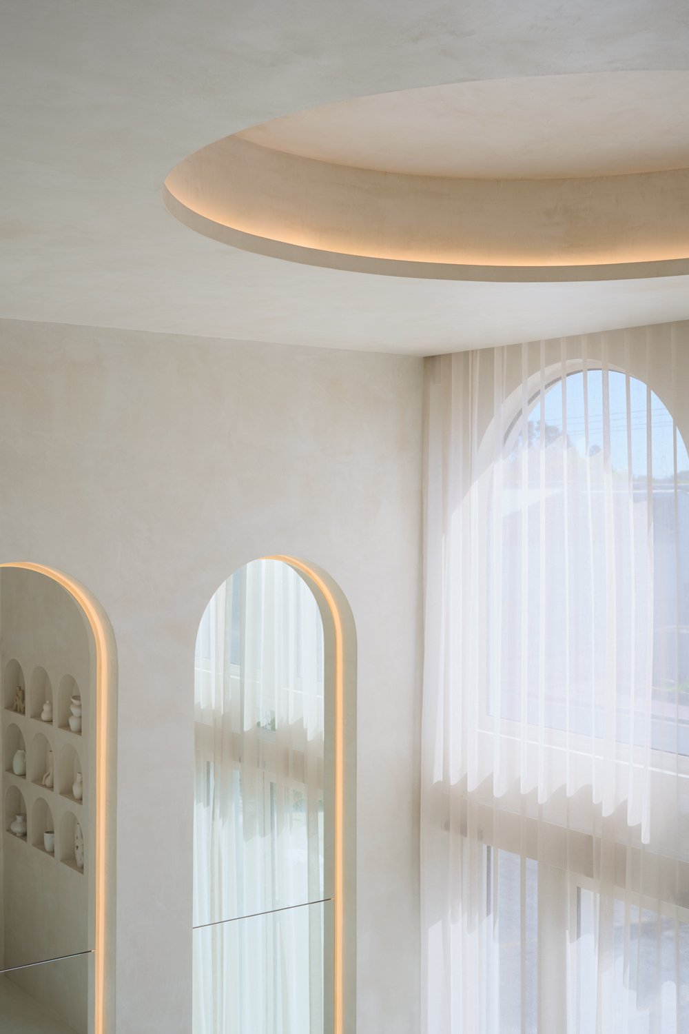 Rounded ceiling detail and arched mirrors at Sculpt Skin Clinic