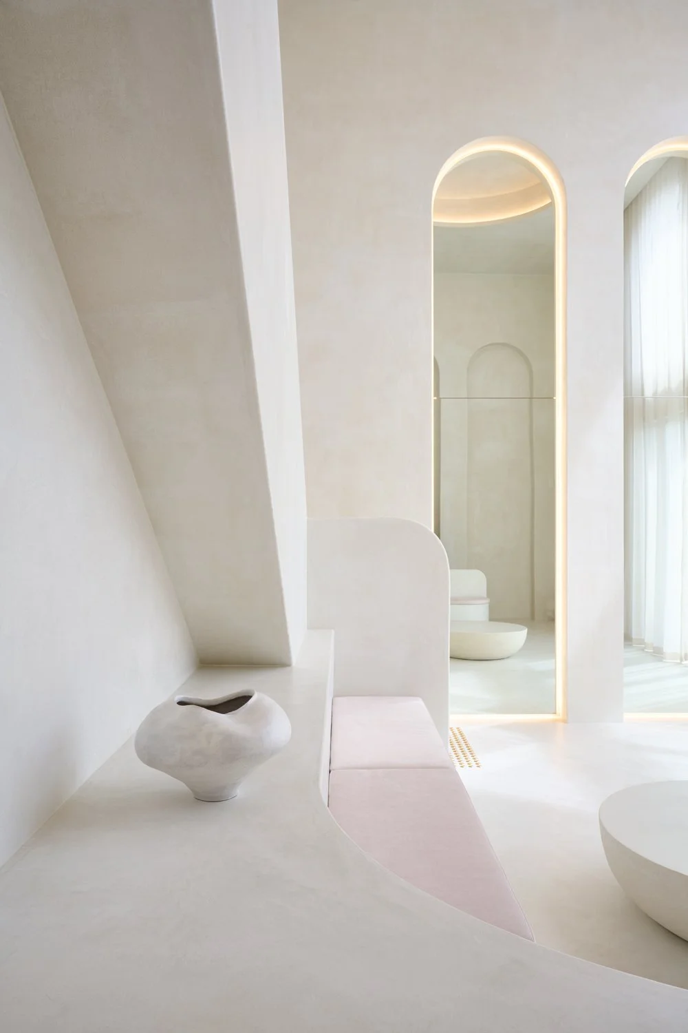 Ceramic décor beside a tall arched mirror at Sculpt Skin Clinic