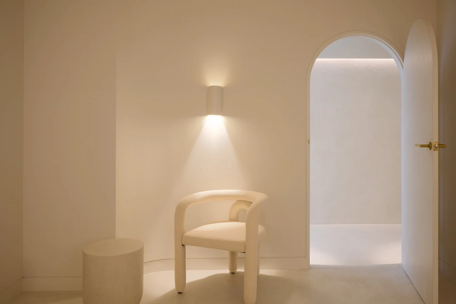 Pale chair and recessed wall light inside Sculpt Skin Clinic