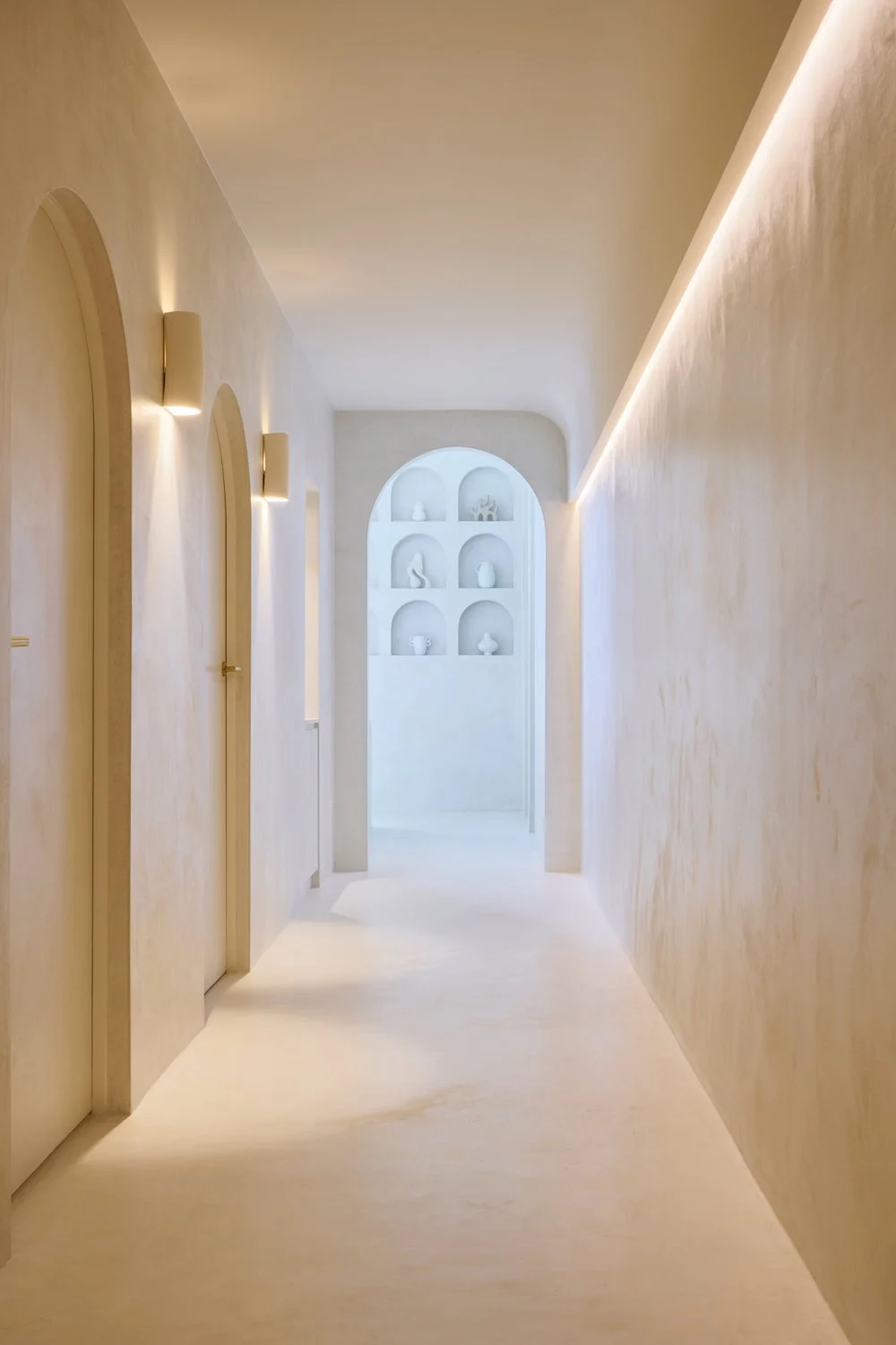 Sculpt Skin Clinic corridor with arched doorways and soft recessed lighting in Stepney