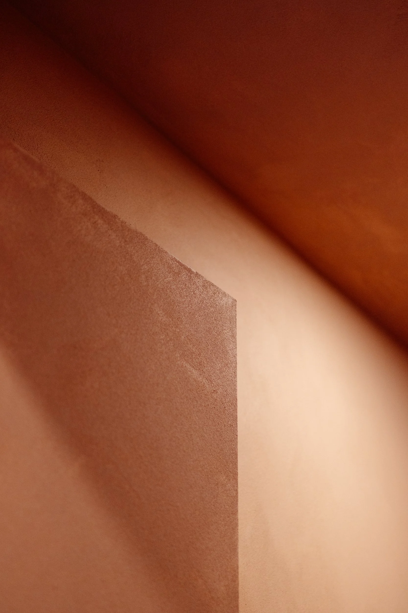 Close-up of textured terracotta wall finishes at Stepney Warehouse