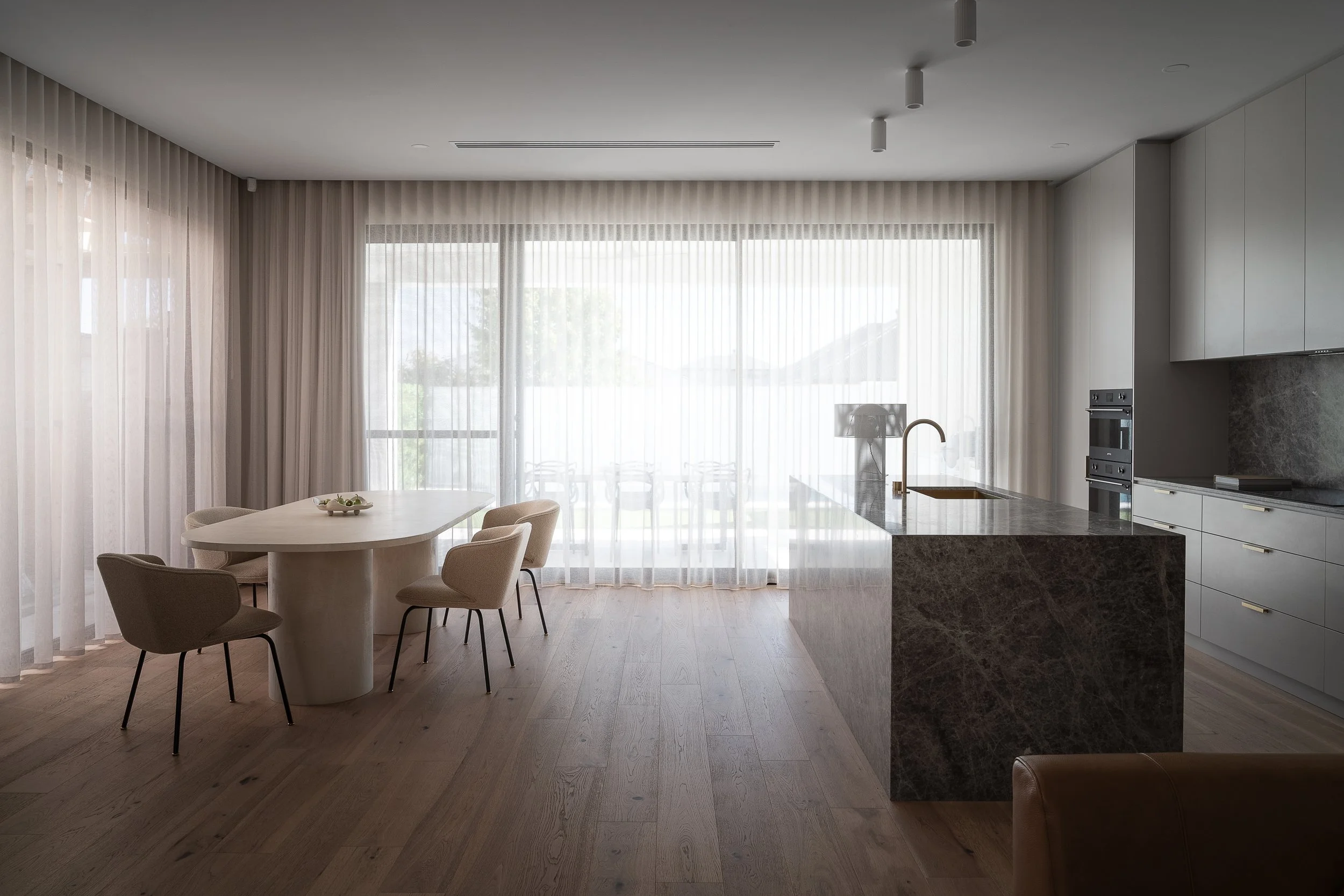 Open-plan dining area beside the kitchen island in Glynde