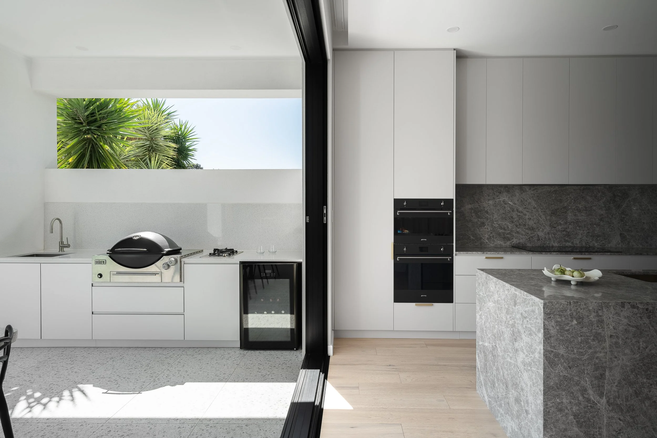 Glynde kitchen opening to an outdoor barbecue area through full-height sliding doors