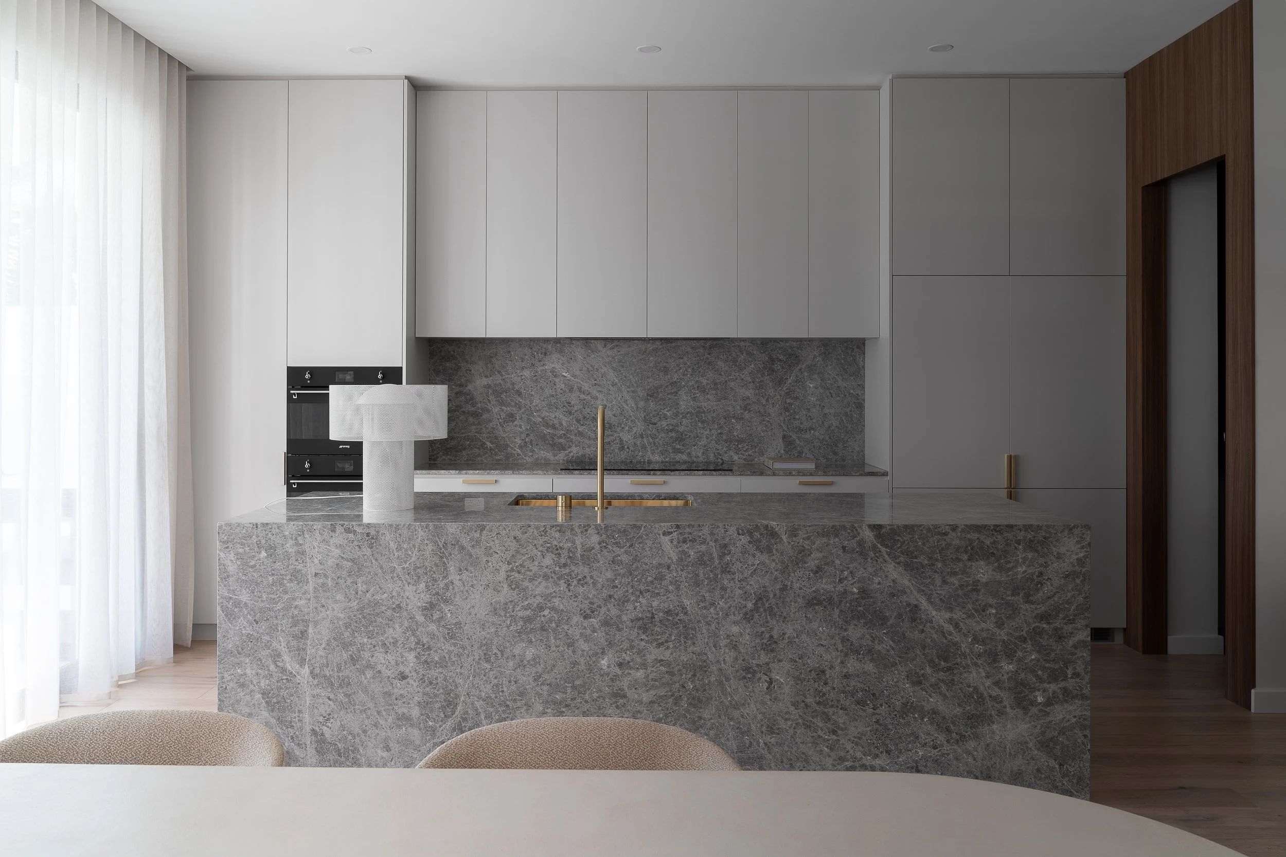 Glynde kitchen with grey cabinetry and a veined stone island
