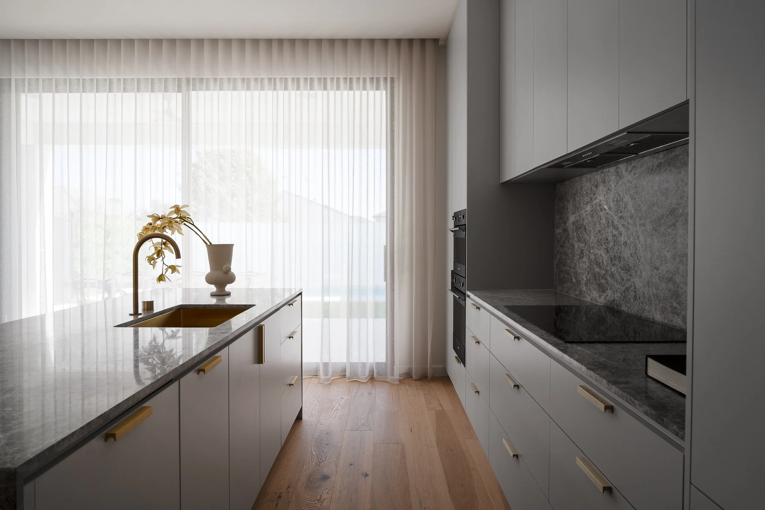 View along the Glynde kitchen towards full-height sheer curtains