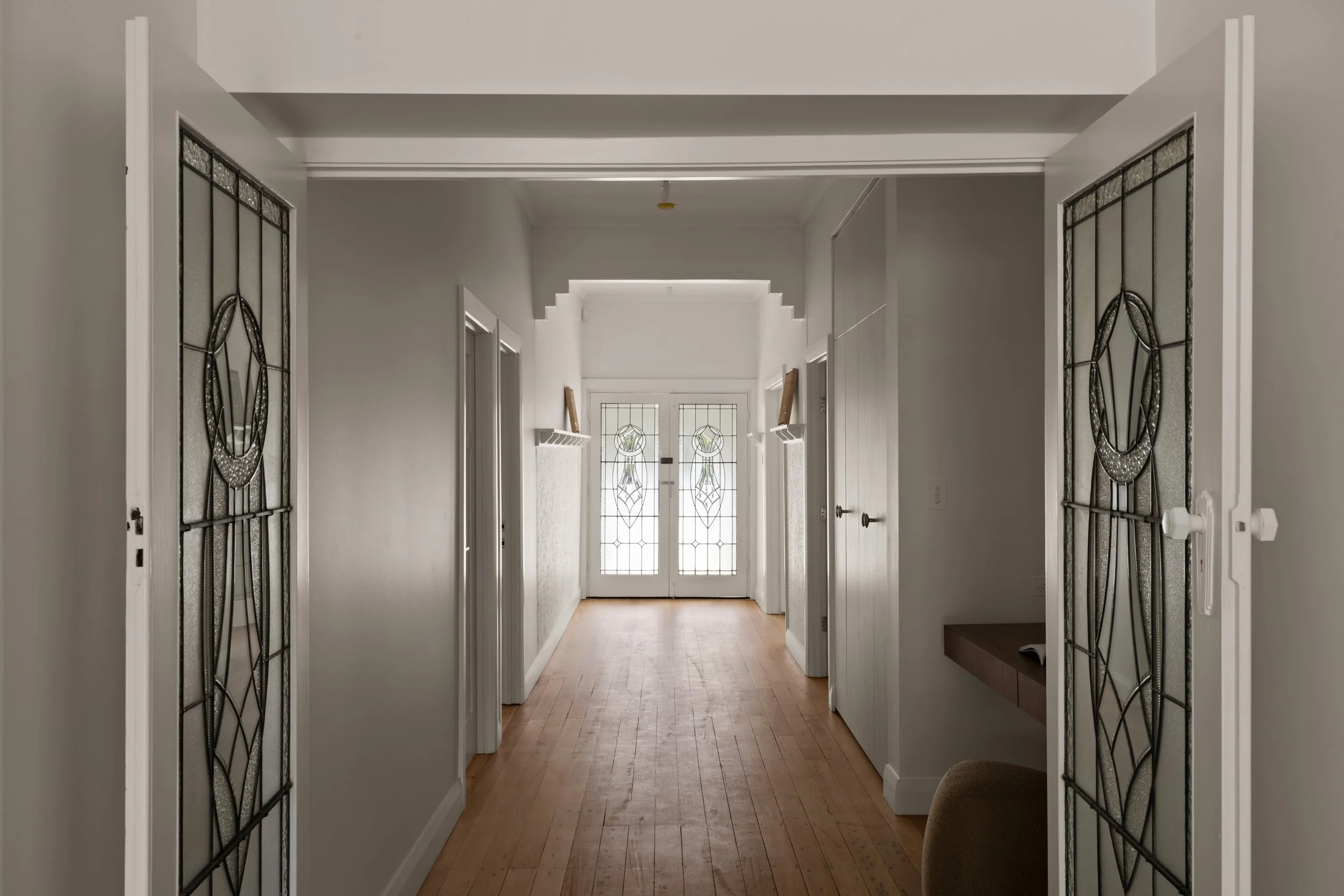 Timber-floored hallway with decorative ceiling details in the Glenelg North home