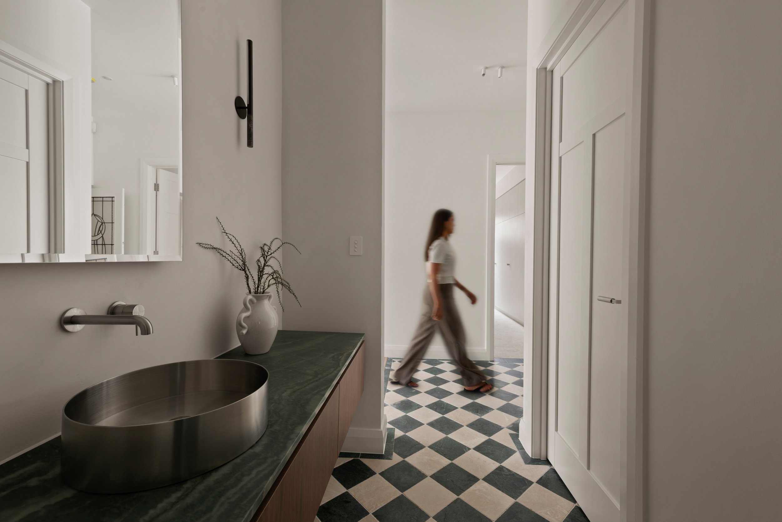 Powder room with checkerboard floor tiles and a green stone vanity in Glenelg North
