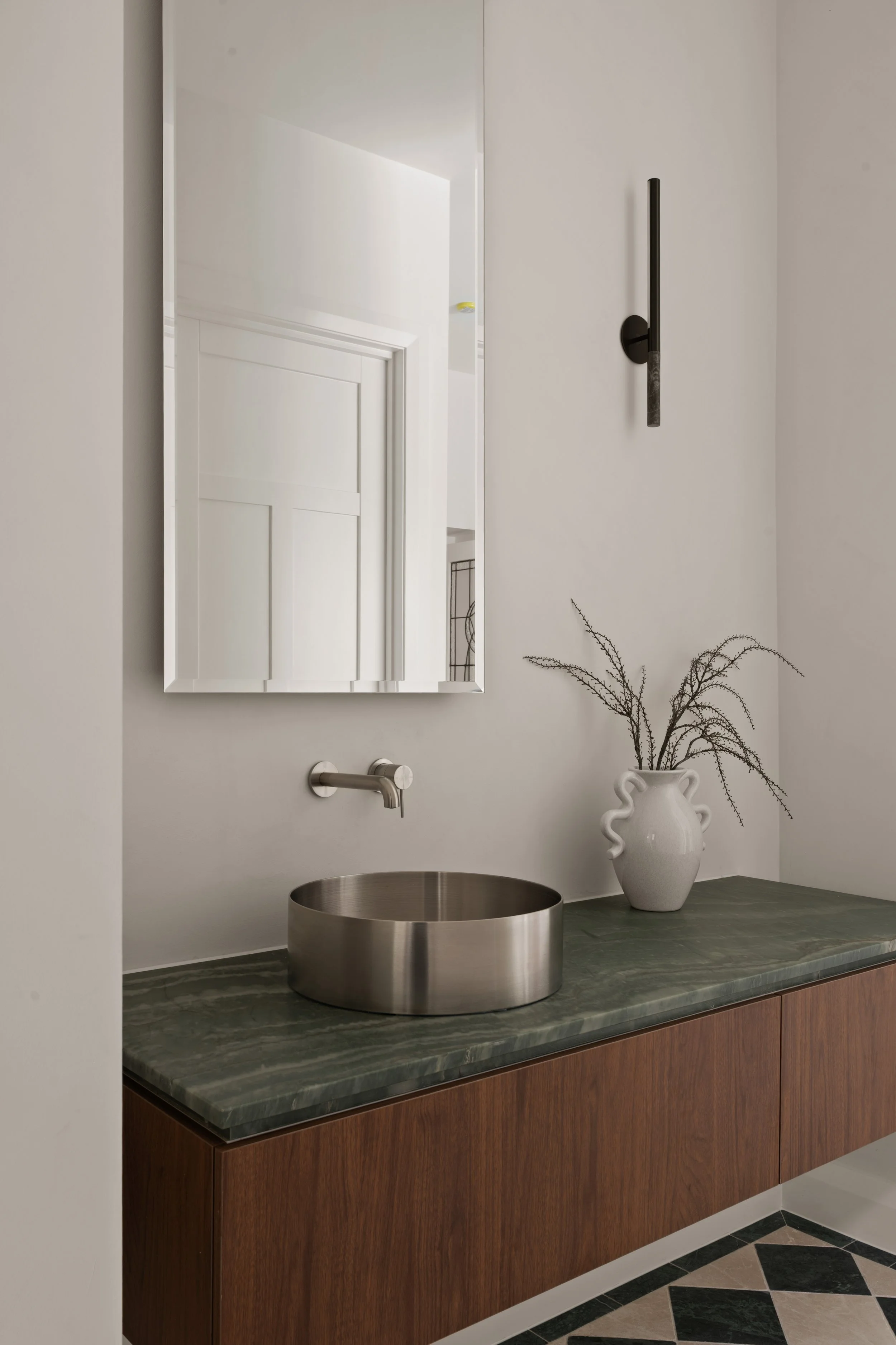 Timber vanity with a green stone benchtop and round basin in Glenelg North