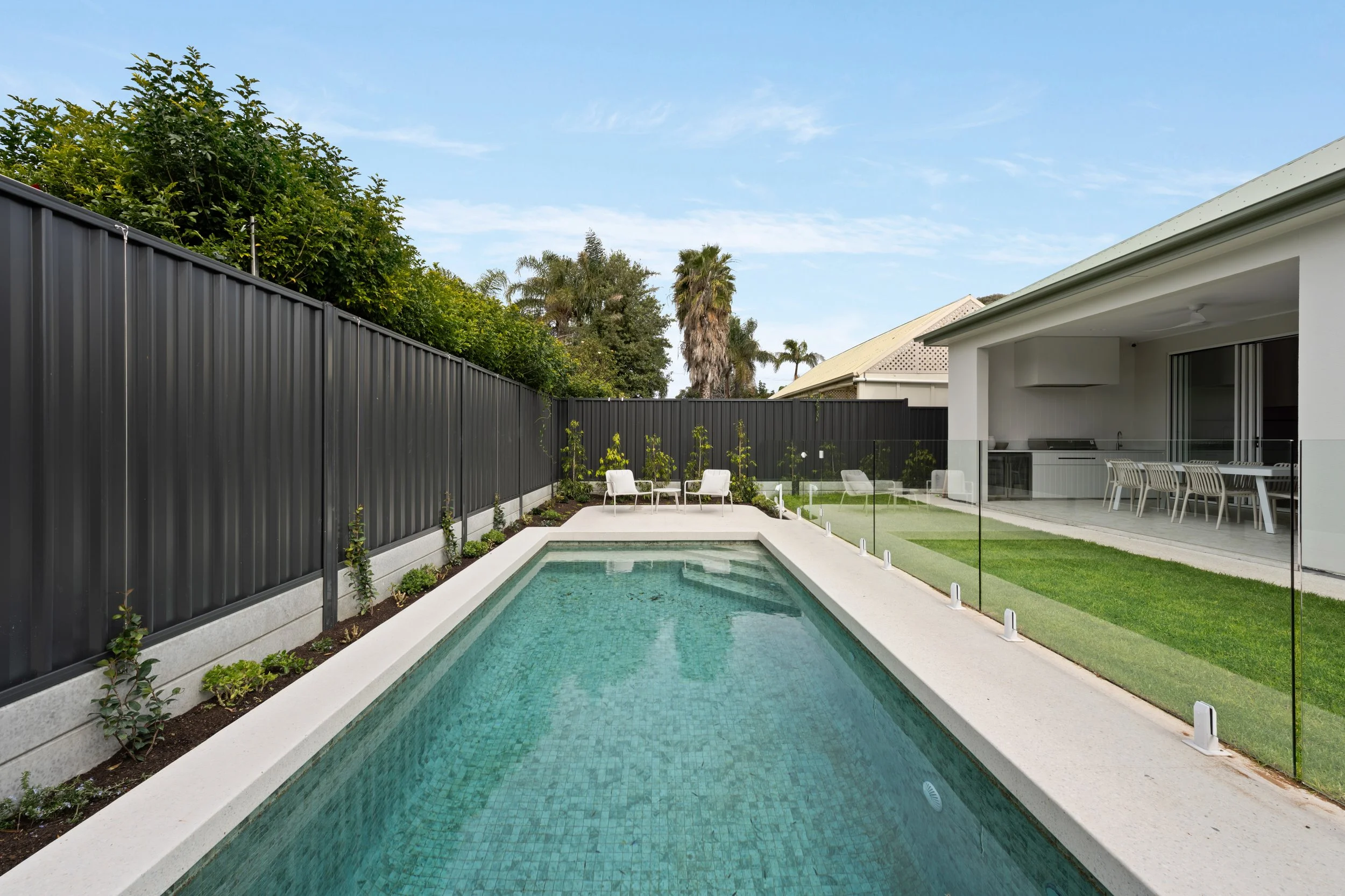 Long swimming pool beside a landscaped garden in Glenelg North