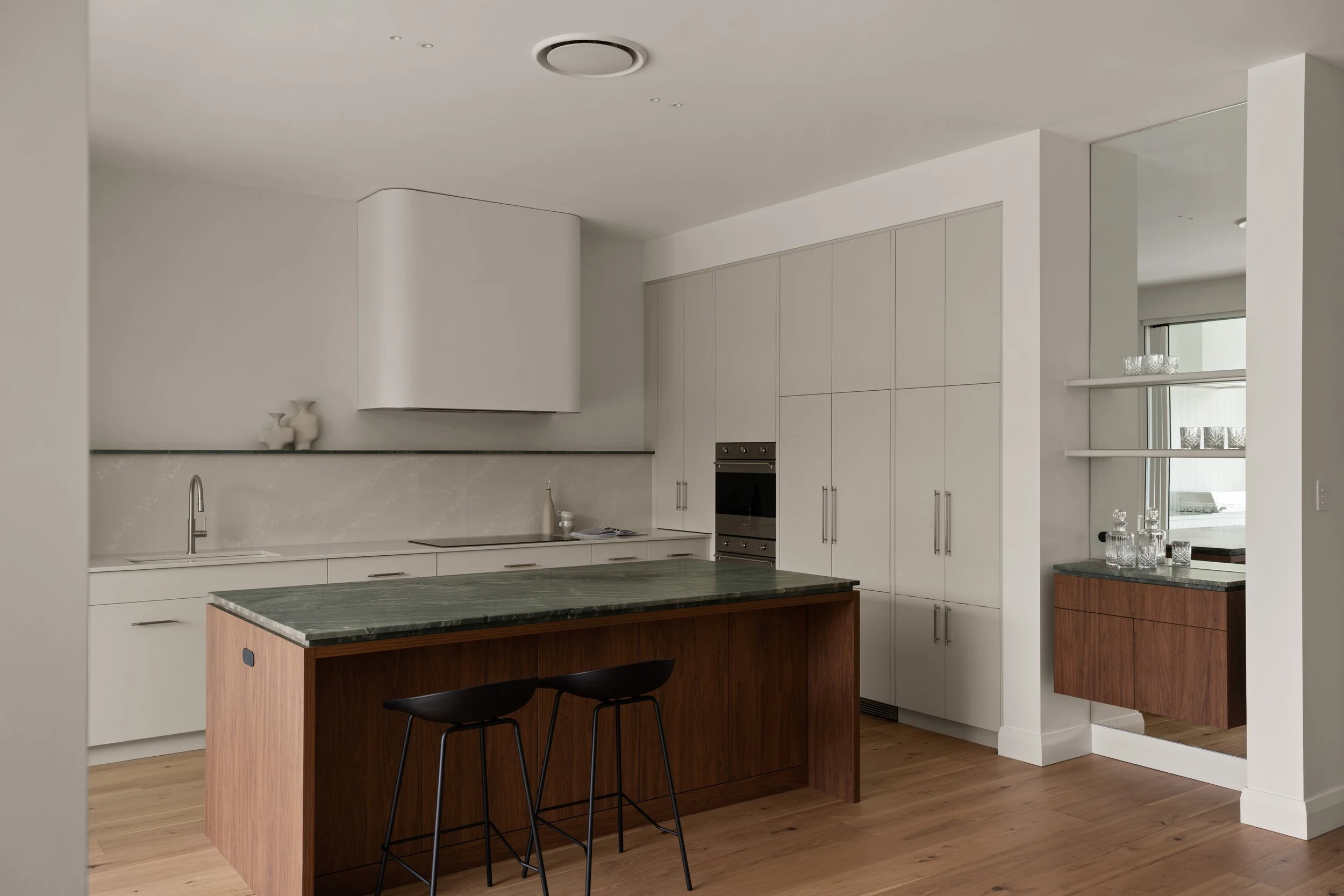 Timber kitchen island and pale cabinetry in Mastacon’s Glenelg North renovation