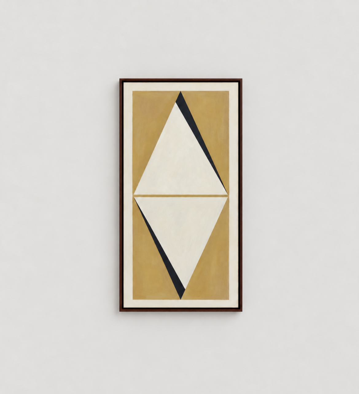 Abstract geometric painting with white, black, and beige shapes on a tan background, framed and hung on a white wall.