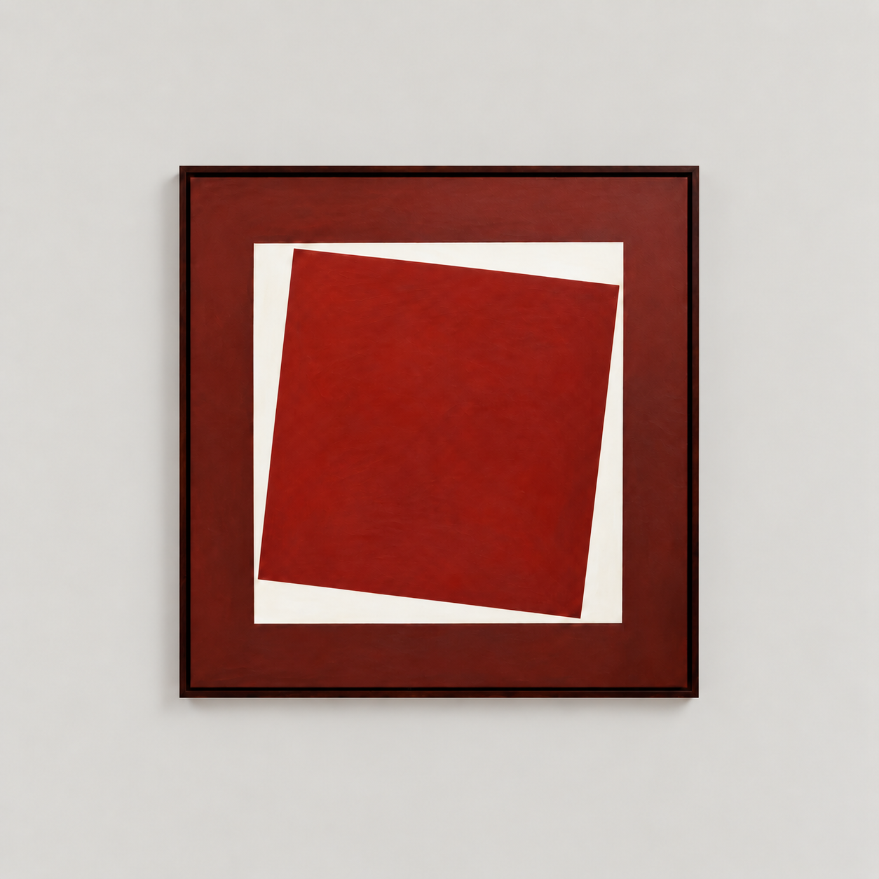 Abstract artwork with red and white geometric shapes on a white wall