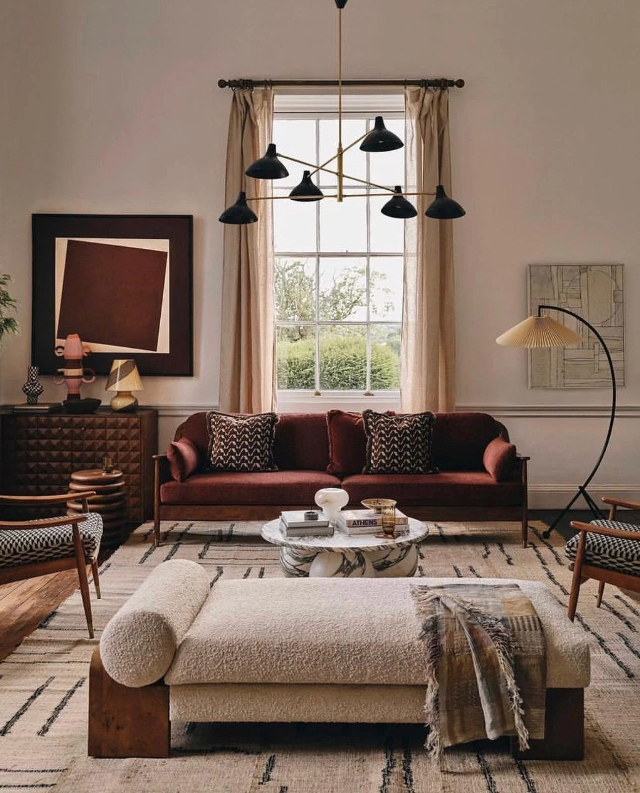Luxury living room with a red velvet sofa and red geometric artwork Presque Rouge by Studio Earle