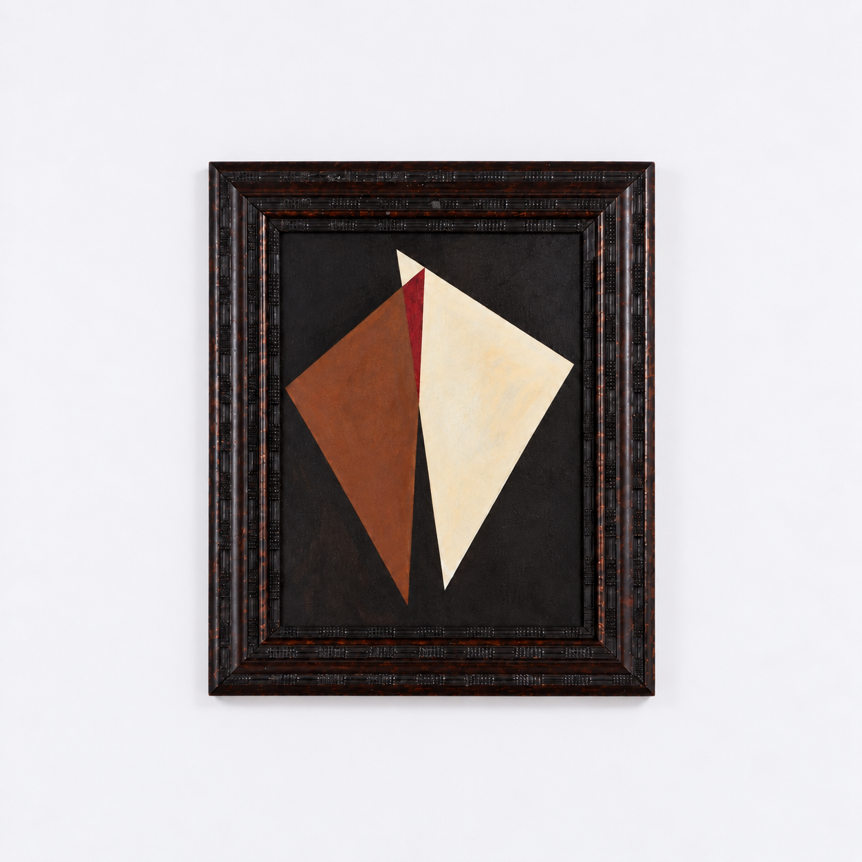 Abstract geometric painting with two large overlapping diamond shapes, one brown and one cream, set in a decorative black frame, displayed against a white wall.