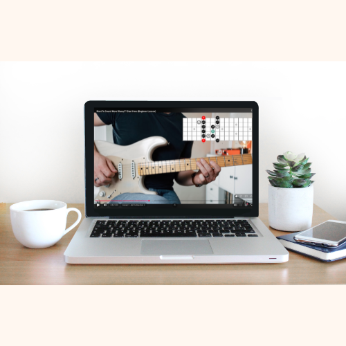 Online guitar lesson with Chris Anthony displayed on a laptop
